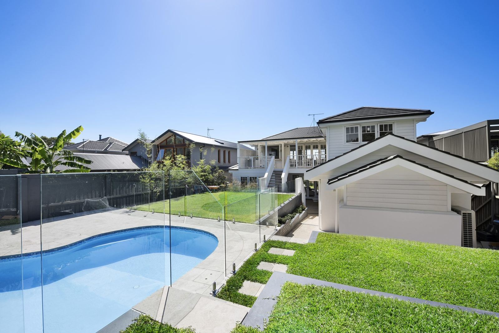Balgowlah Heights — rear garden with swimming pool, glass fencing, lawn and garage, built by HP Constructions with All Australian Architecture