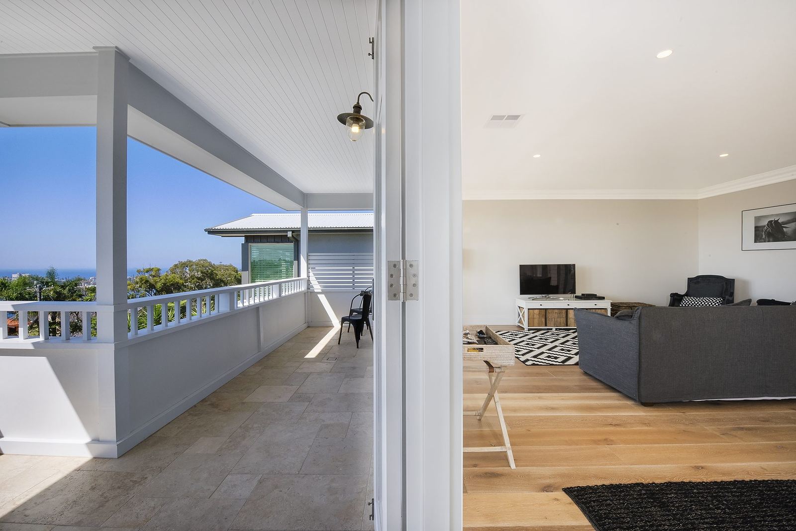 Balgowlah Heights — covered balcony with coastal view opening to the living room, built by HP Constructions with All Australian Architecture