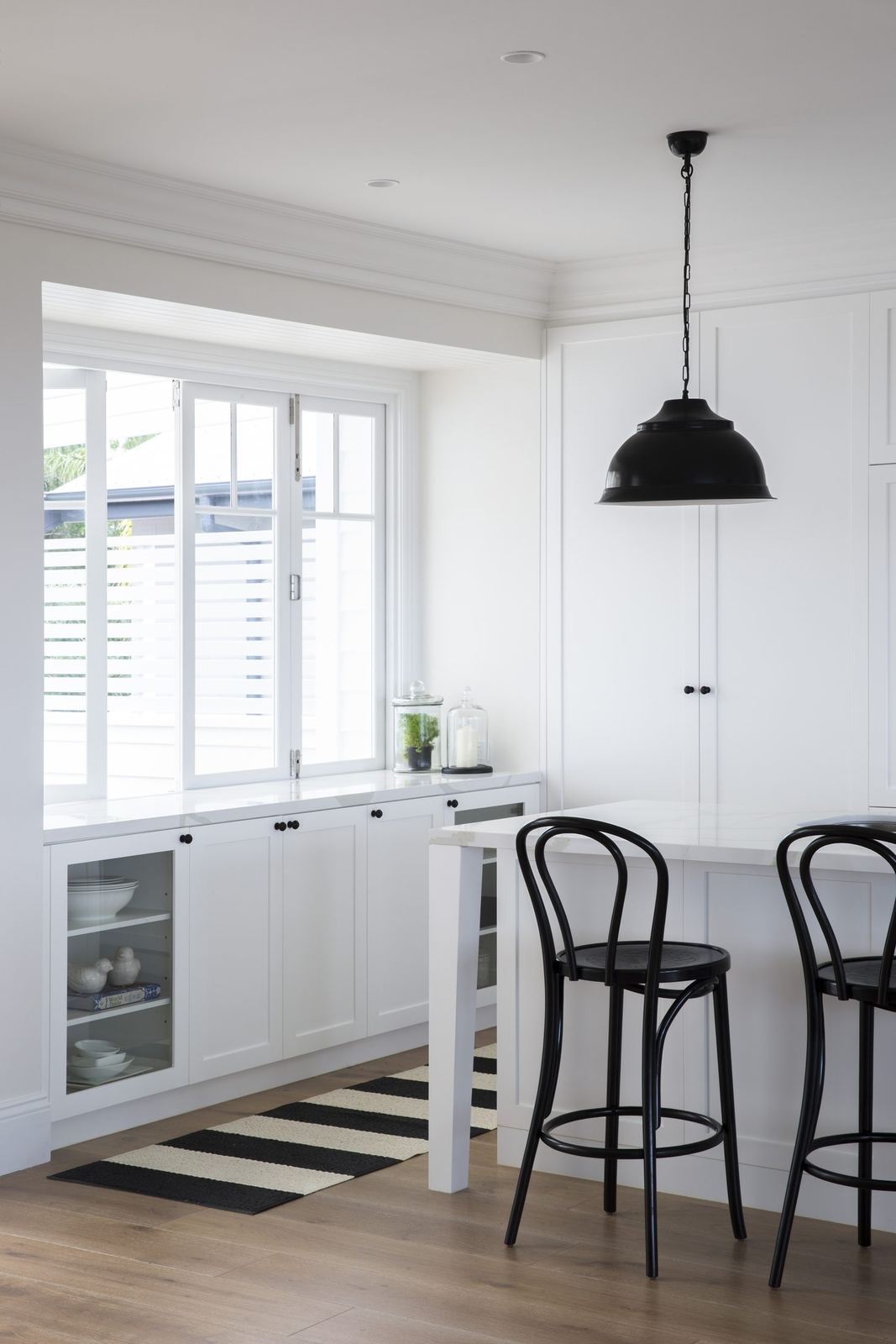 Balgowlah Heights — kitchen nook with high white table, black bentwood stools and pendant, built by HP Constructions with All Australian Architecture