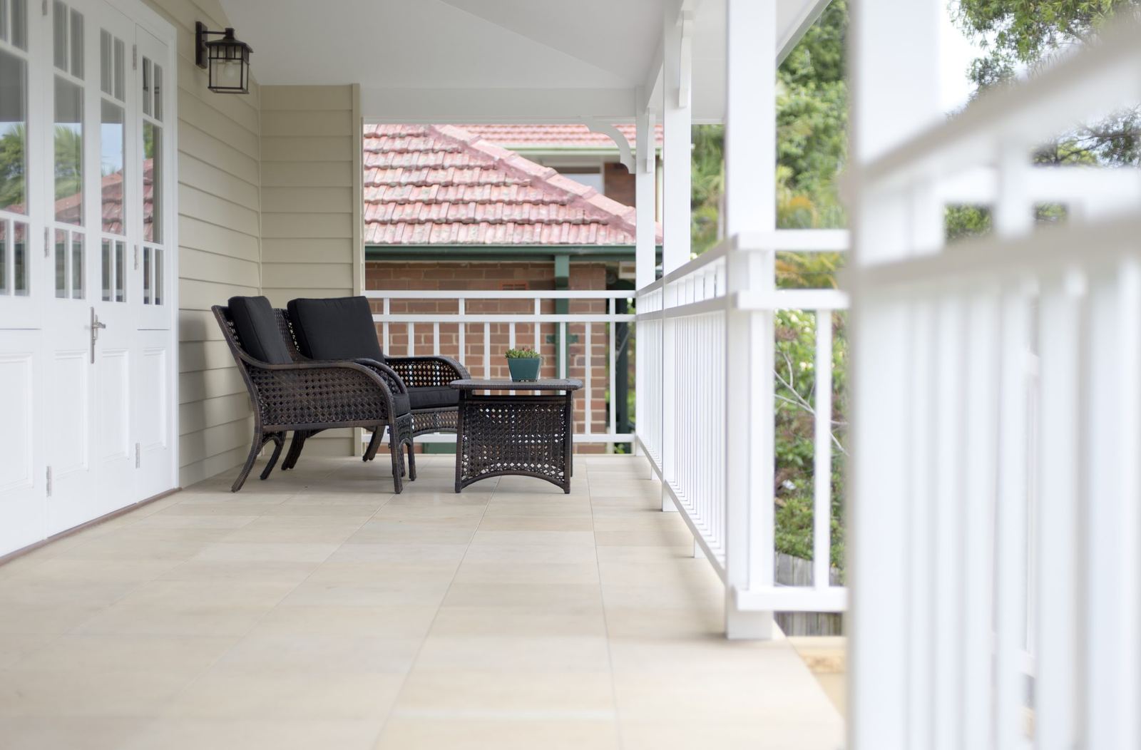 Balgowlah — covered veranda with white timber doors, tiled floor and outdoor seating, built by HP Constructions with Scope Architects