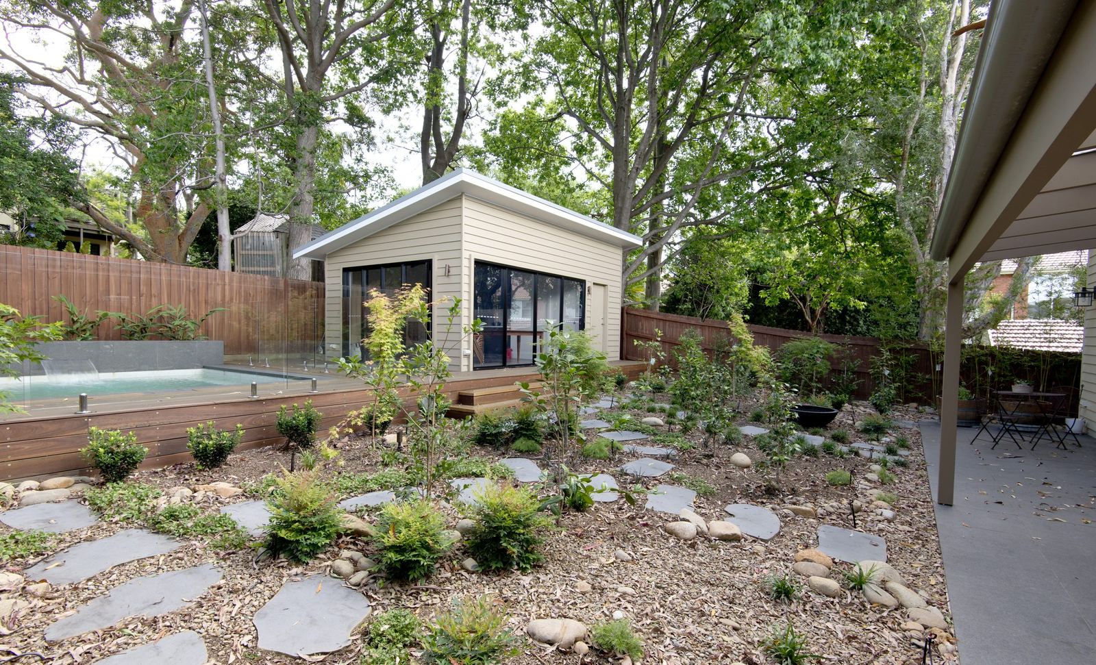 Balgowlah — landscaped rear garden with cabana, concrete pool and stone stepping paving, built by HP Constructions with Scope Architects