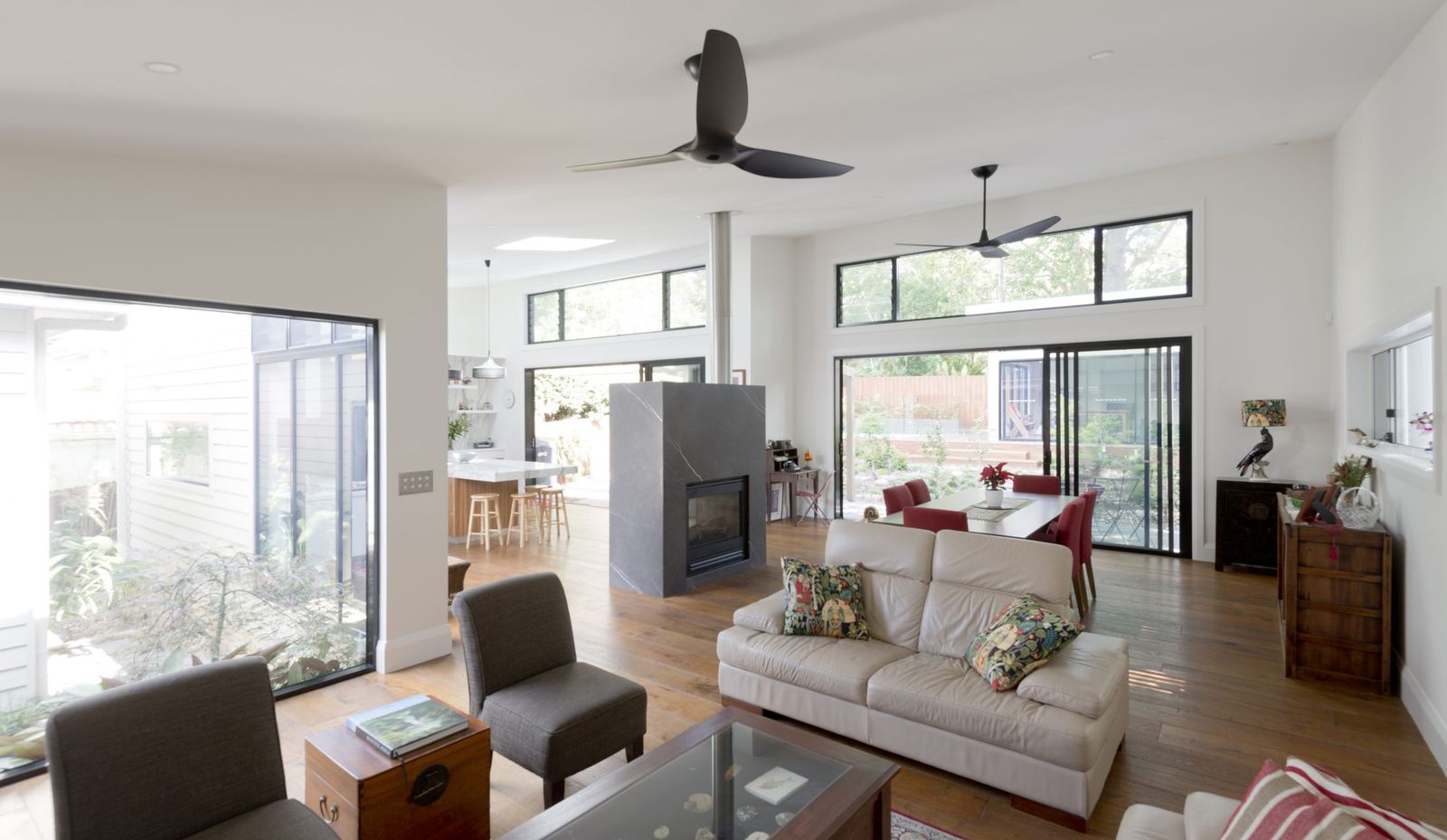 Balgowlah — open living room with fireplace, ceiling fan and view to the kitchen, built by HP Constructions with Scope Architects