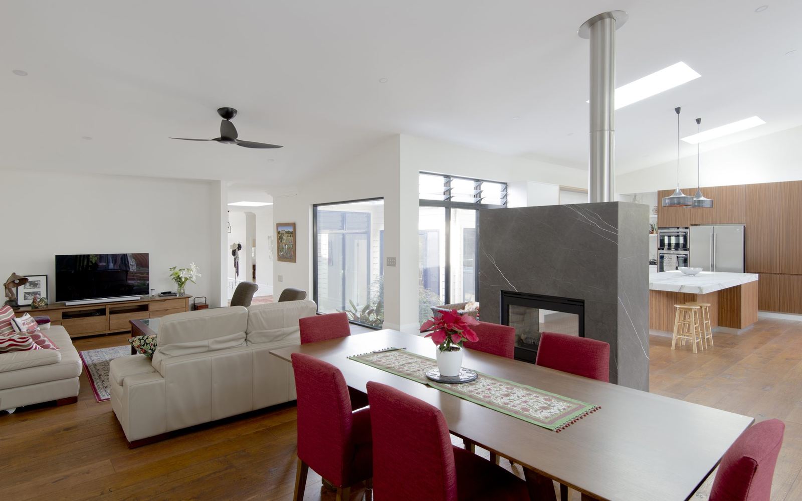 Balgowlah — open-plan living and dining with a stone fireplace and dining table, built by HP Constructions with Scope Architects