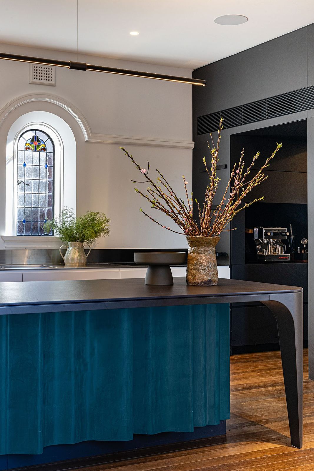 Bellevue Hill — kitchen island with fluted teal base and timber top below an arched window, built by HP Constructions with Foster & Associates