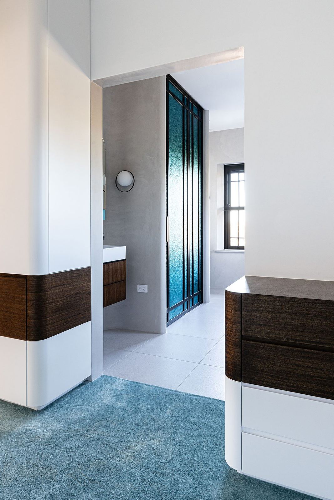 Bellevue Hill — hallway with white and dark timber joinery and teal flooring, built by HP Constructions with Foster & Associates