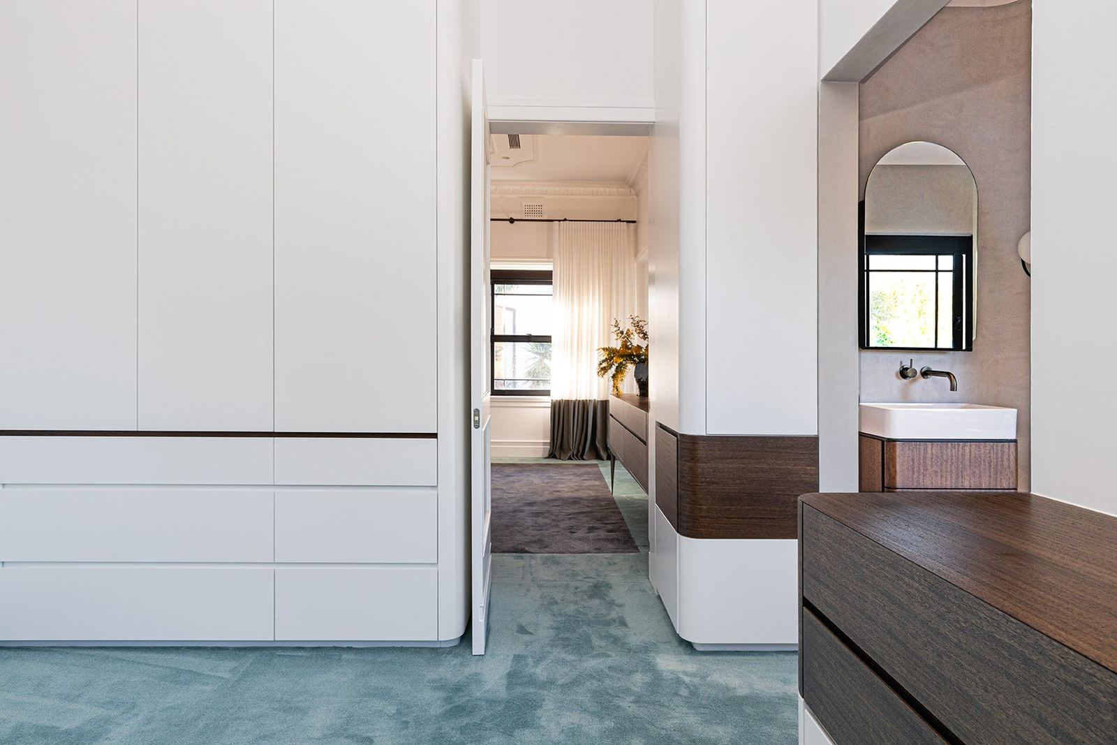 Bellevue Hill — walk-in robe with white joinery and teal carpet beside a vanity, built by HP Constructions with Foster & Associates