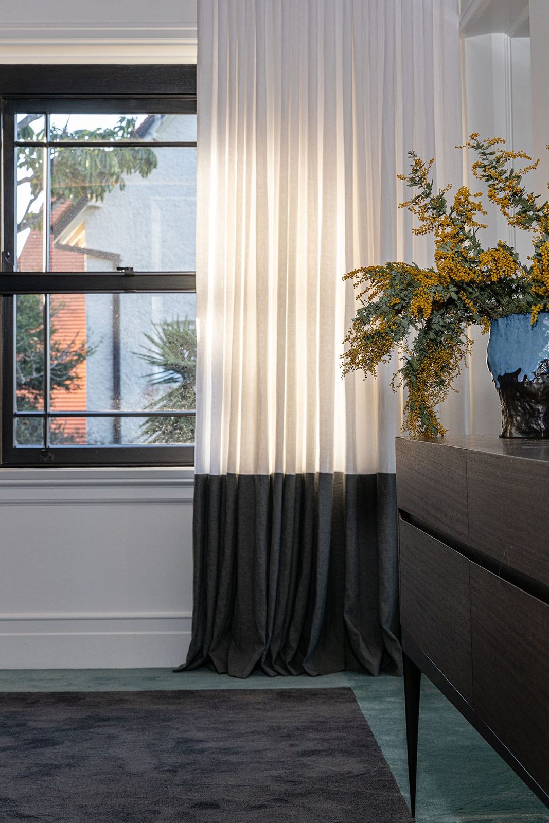 Bellevue Hill — bedroom corner with black-framed window, sheer curtains and timber sideboard, built by HP Constructions with Foster & Associates