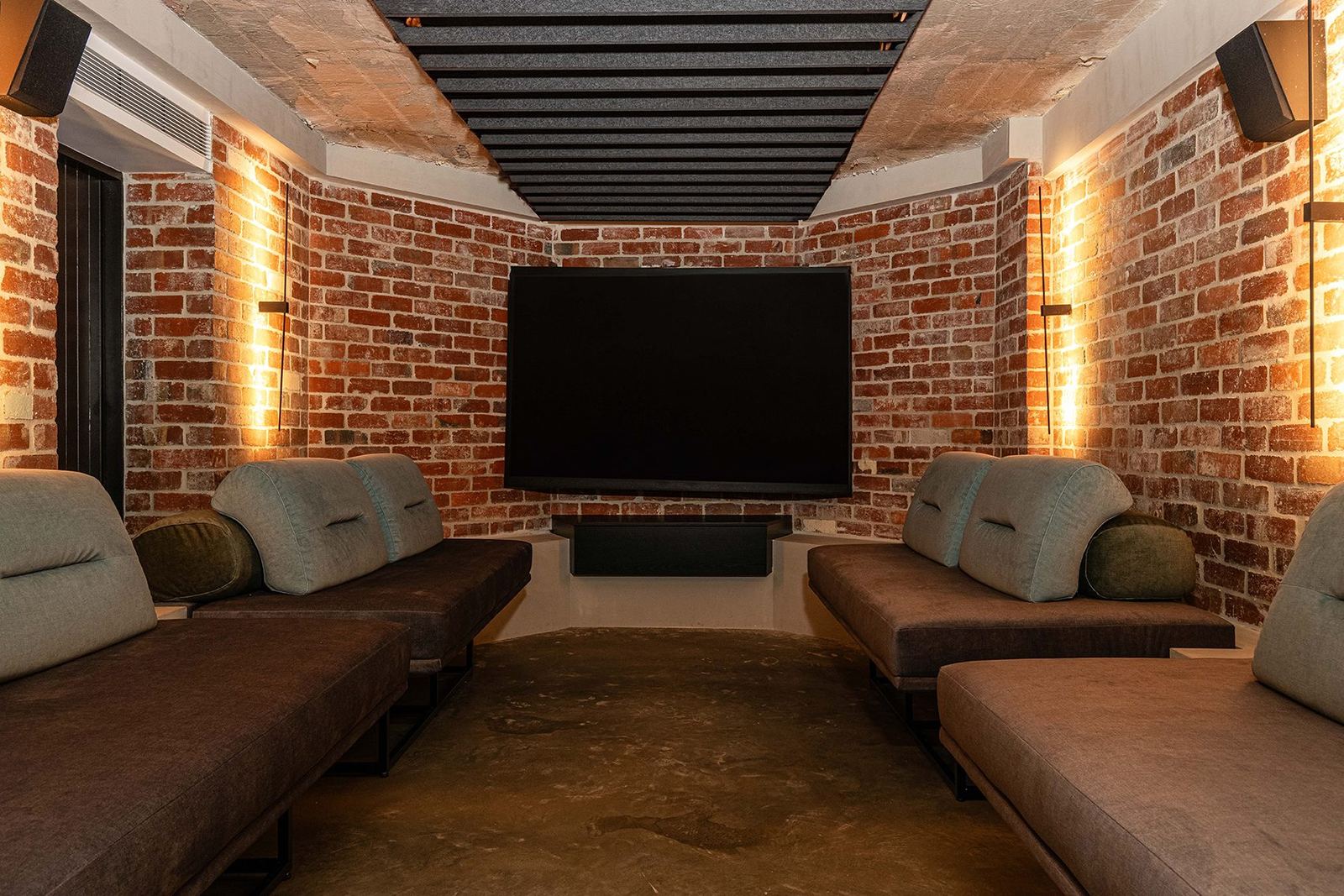 Bellevue Hill — brick-walled cinema room with black-beamed ceiling, wall TV and chaise lounges, built by HP Constructions with Foster & Associates