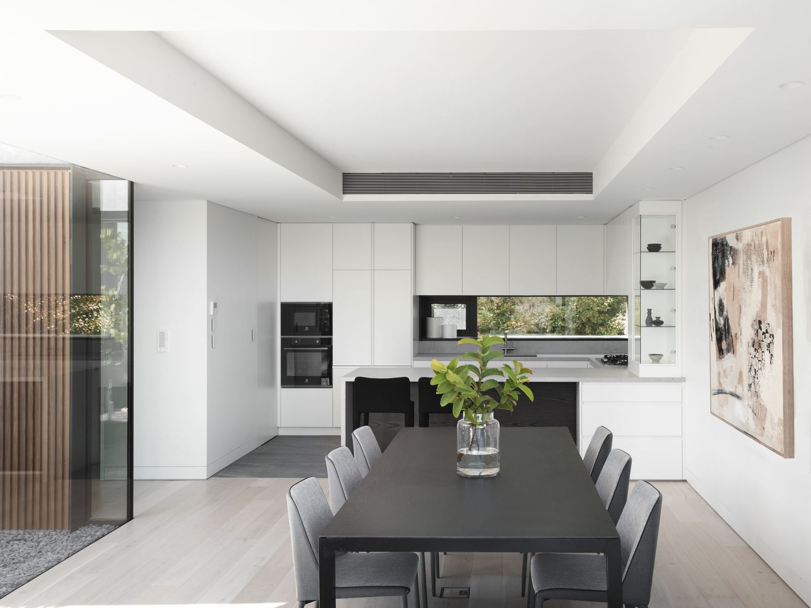 Castle Cove — white kitchen and dining with black table and timber joinery, built by HP Constructions with Dieppe Design