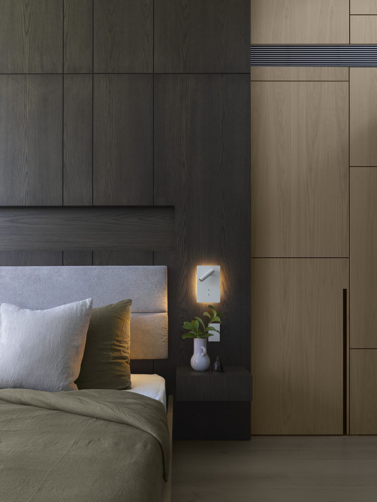 Castle Cove — bedroom with timber joinery, green bedding and wall light, built by HP Constructions with Dieppe Design