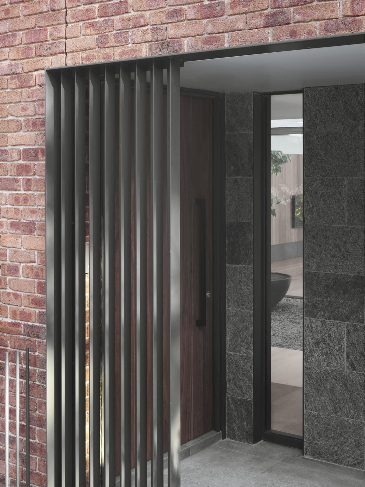 Castle Cove — exterior detail of brick wall with dark timber sliding screen, built by HP Constructions with Dieppe Design
