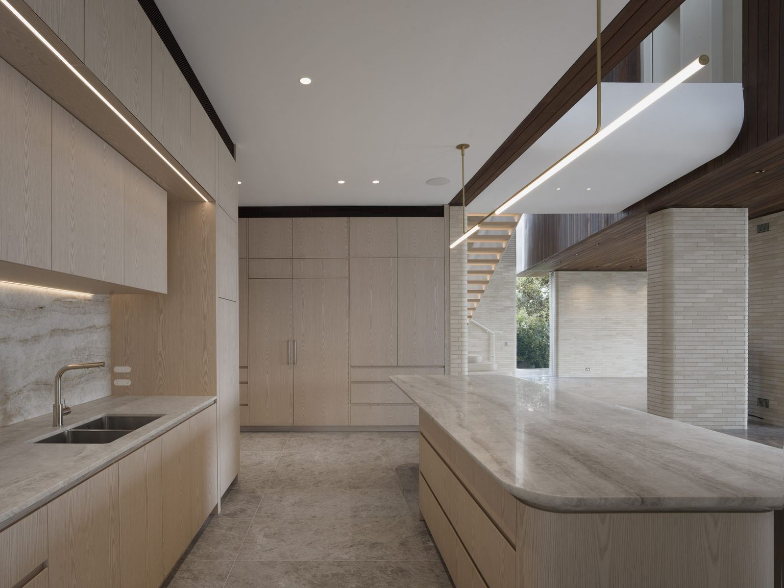 Castlecrag — kitchen with pale timber joinery, stone island and linear pendant, built by HP Constructions with FJC Studio