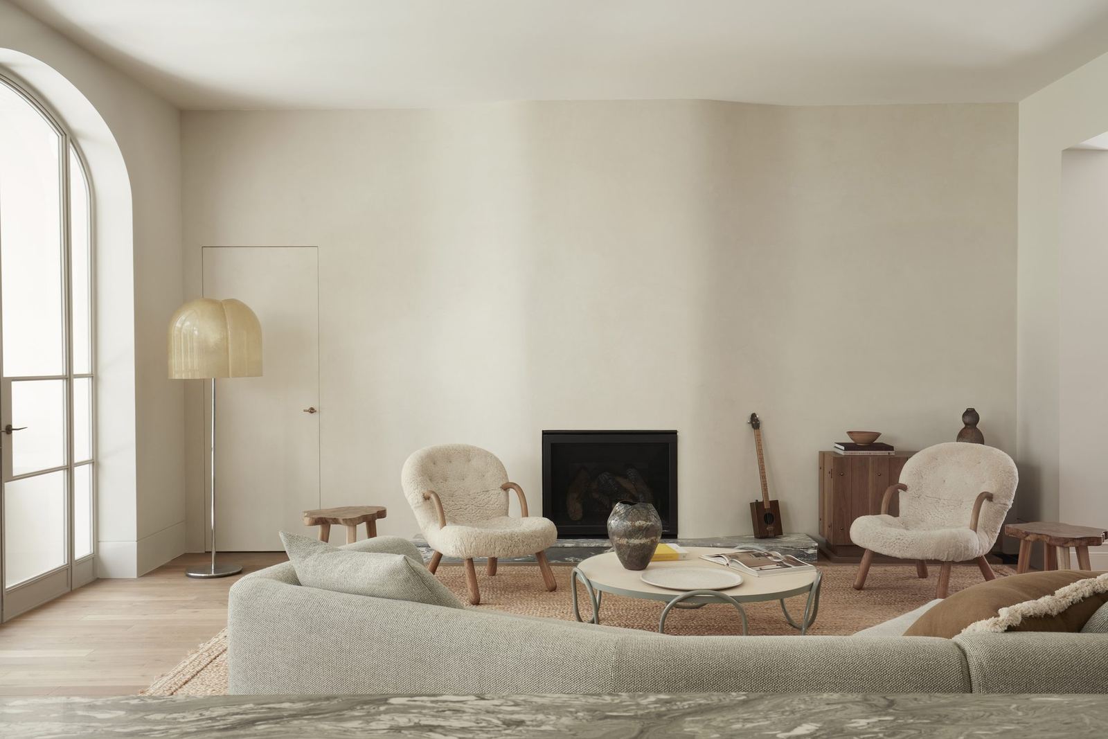 Darling Point — living room with arched windows, fireplace and curved sofa, built by HP Constructions with Hancock Architects