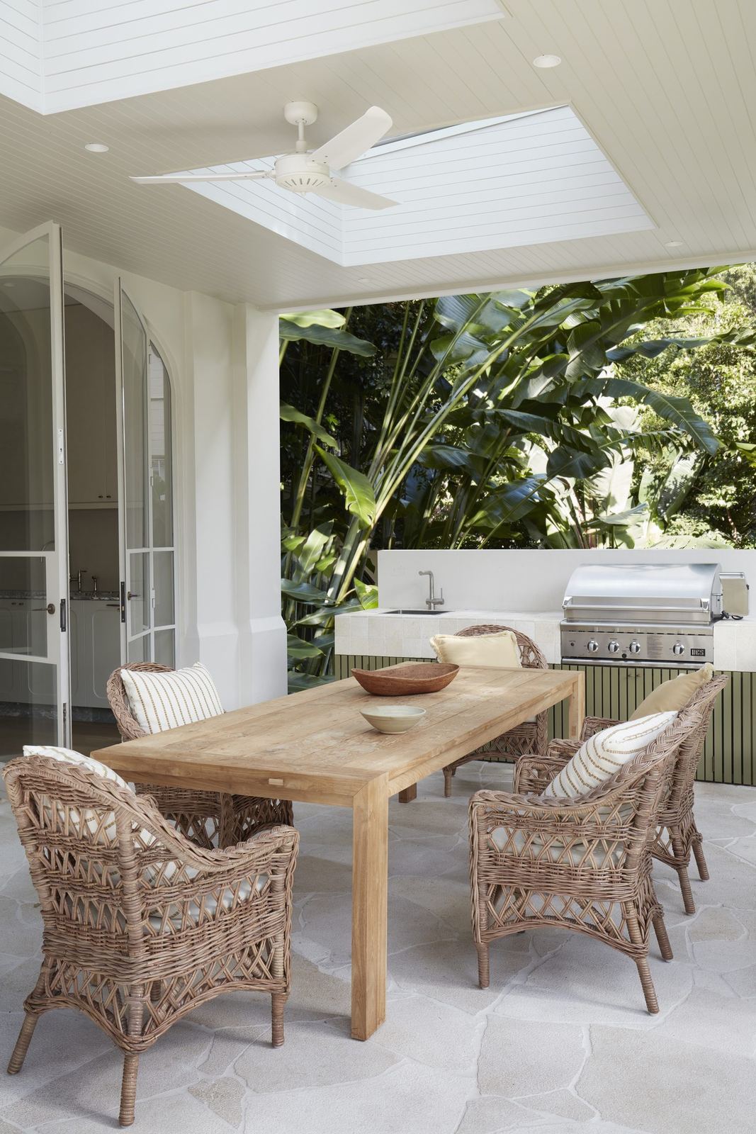 Darling Point — covered terrace with timber dining table, wicker chairs and skylight, built by HP Constructions with Hancock Architects