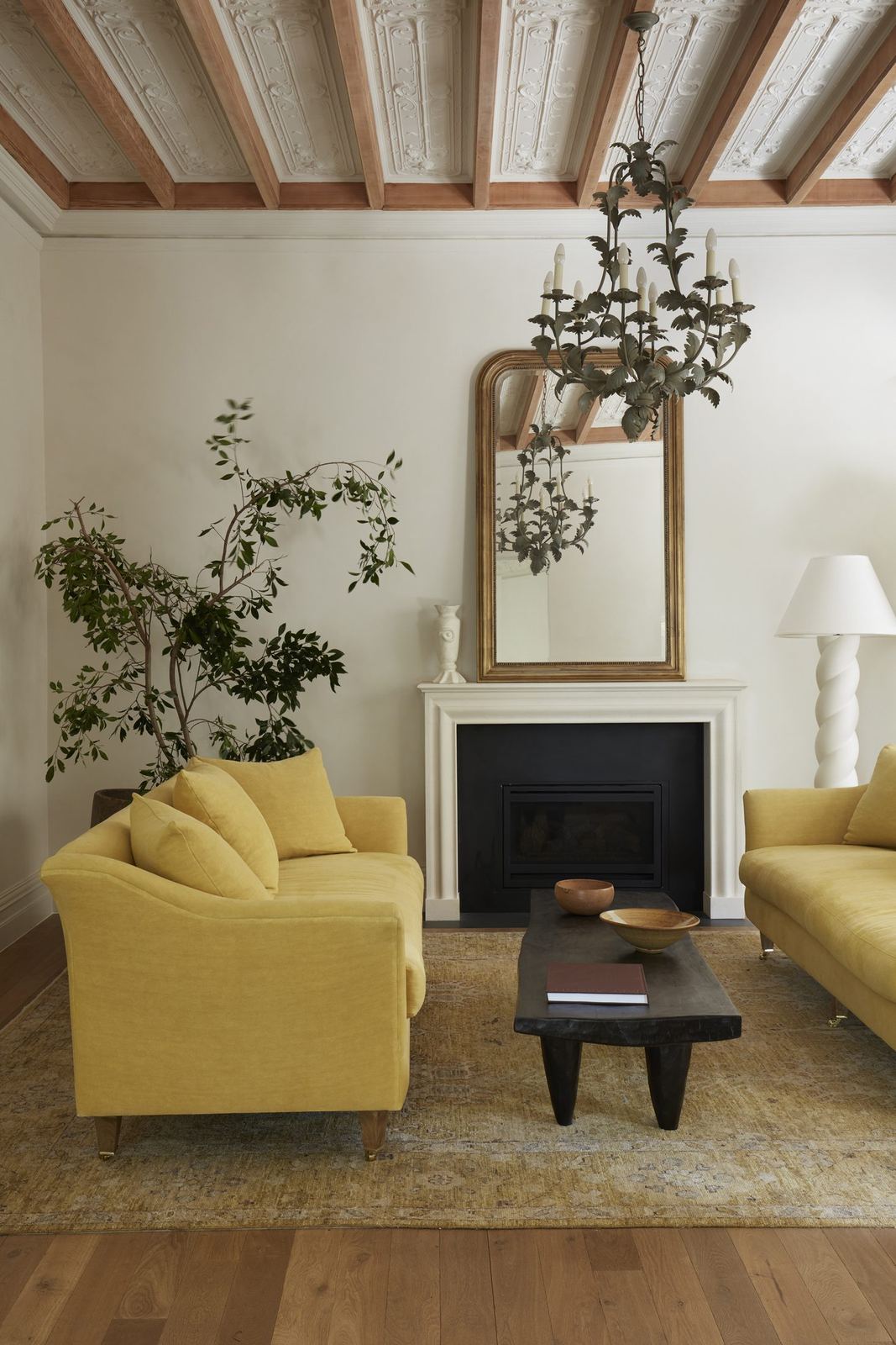 Darling Point — sitting room with fireplace, gilt mirror and exposed timber beams, built by HP Constructions with Hancock Architects
