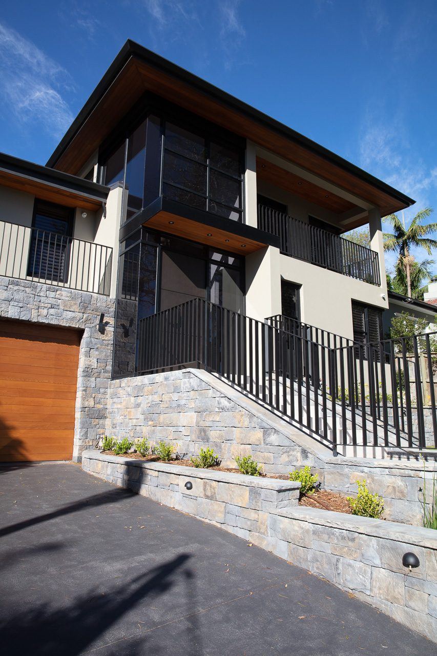 Hunters Hill — street view of multi-level home with stone base and metal fencing, built by HP Constructions with Dale Design Group