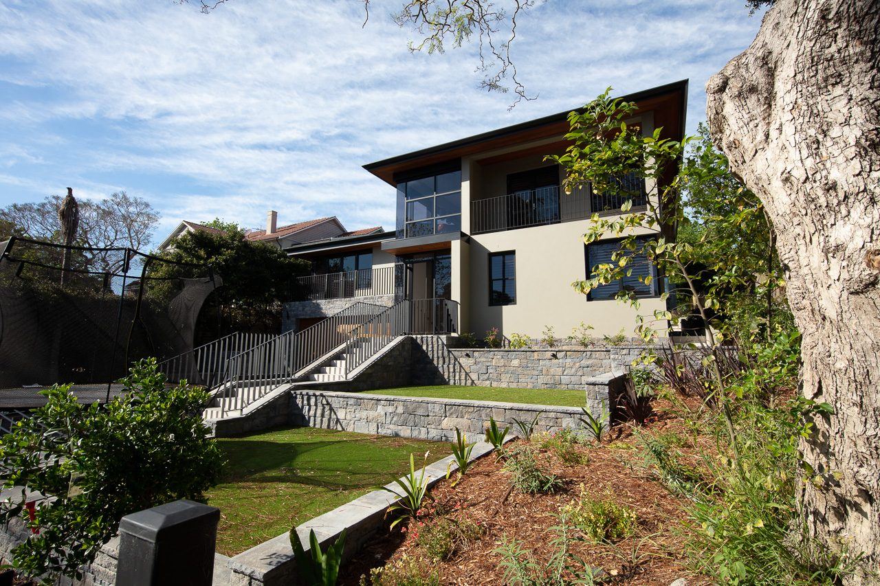 Hunters Hill — garden view of home from lawn with sandstone rock outcrop, built by HP Constructions with Dale Design Group