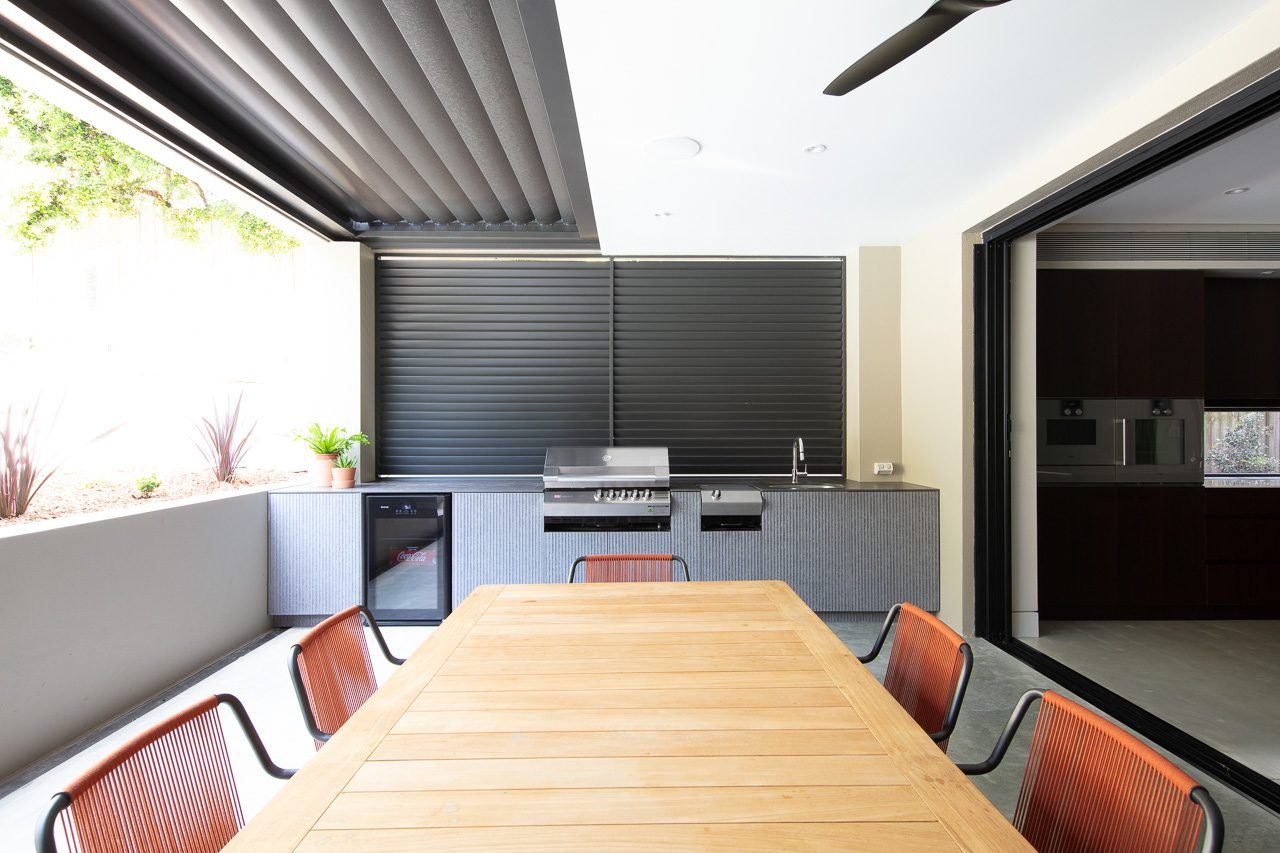Hunters Hill — outdoor kitchen with timber dining table and stainless barbecue, built by HP Constructions with Dale Design Group