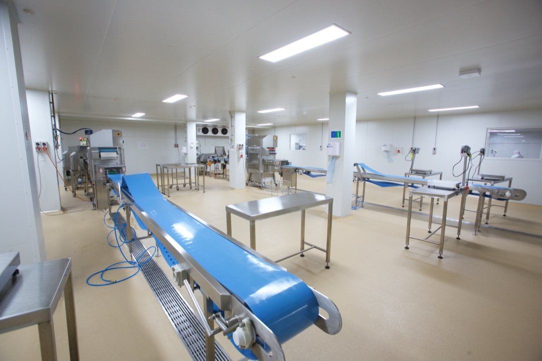 Kitchen Food Company — production line with blue conveyor belts and stainless tables, built by HP Constructions