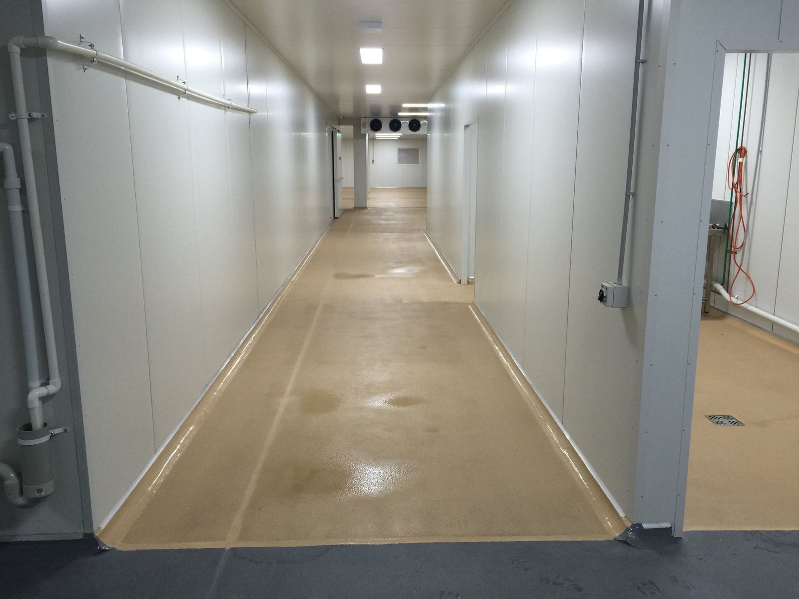 Kitchen Food Company — long refrigerated cold-store corridor with white panel walls, built by HP Constructions