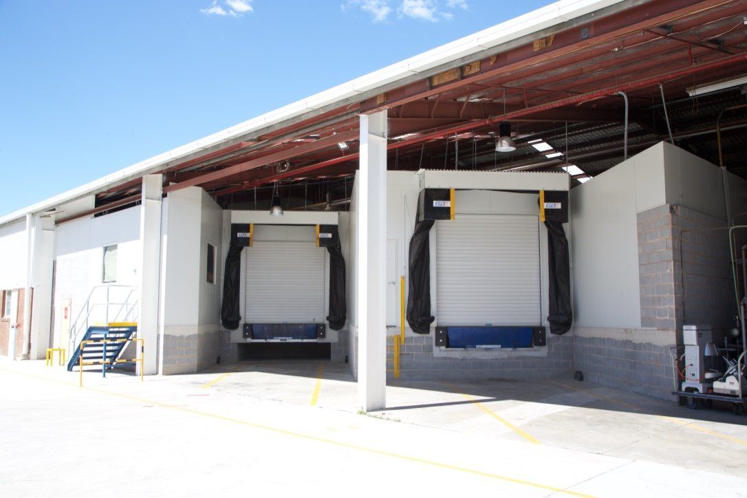 Kitchen Food Company — exterior loading docks with roller doors and dock levellers, built by HP Constructions