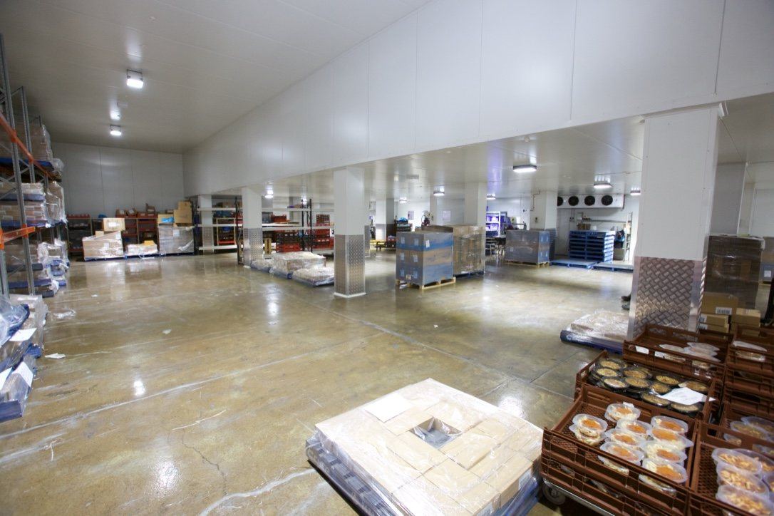 Kitchen Food Company — large refrigerated storeroom with shelving and product pallets, built by HP Constructions