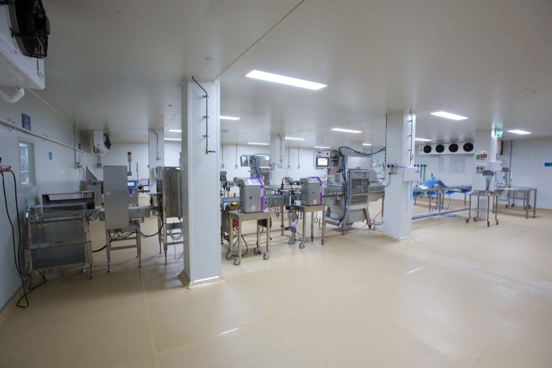 Kitchen Food Company — production room with stainless-steel processing machinery, built by HP Constructions