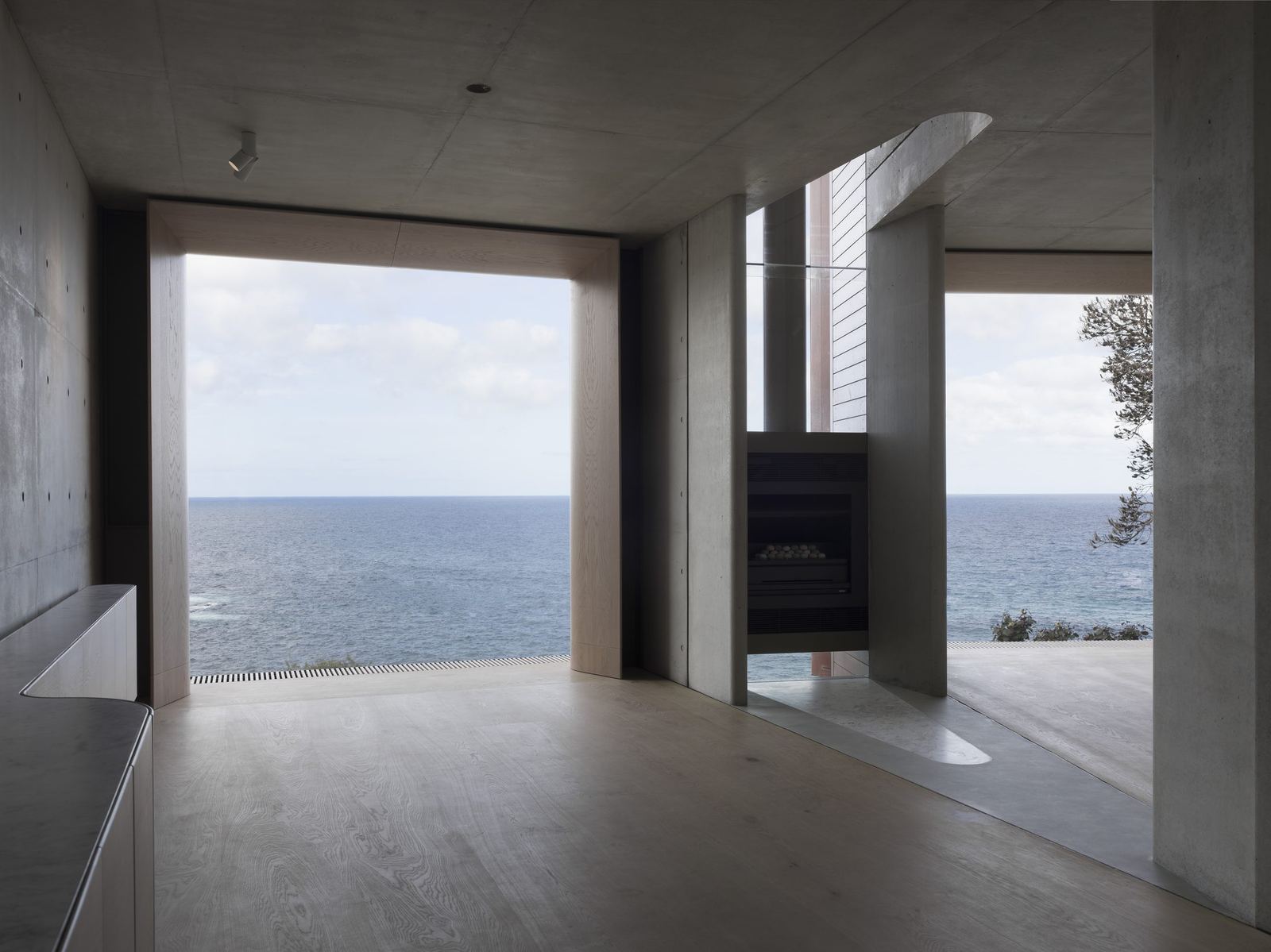 Lurline Bay — living room with floor-to-ceiling ocean glazing and off-form concrete walls, built by HP Constructions with FJC Studio