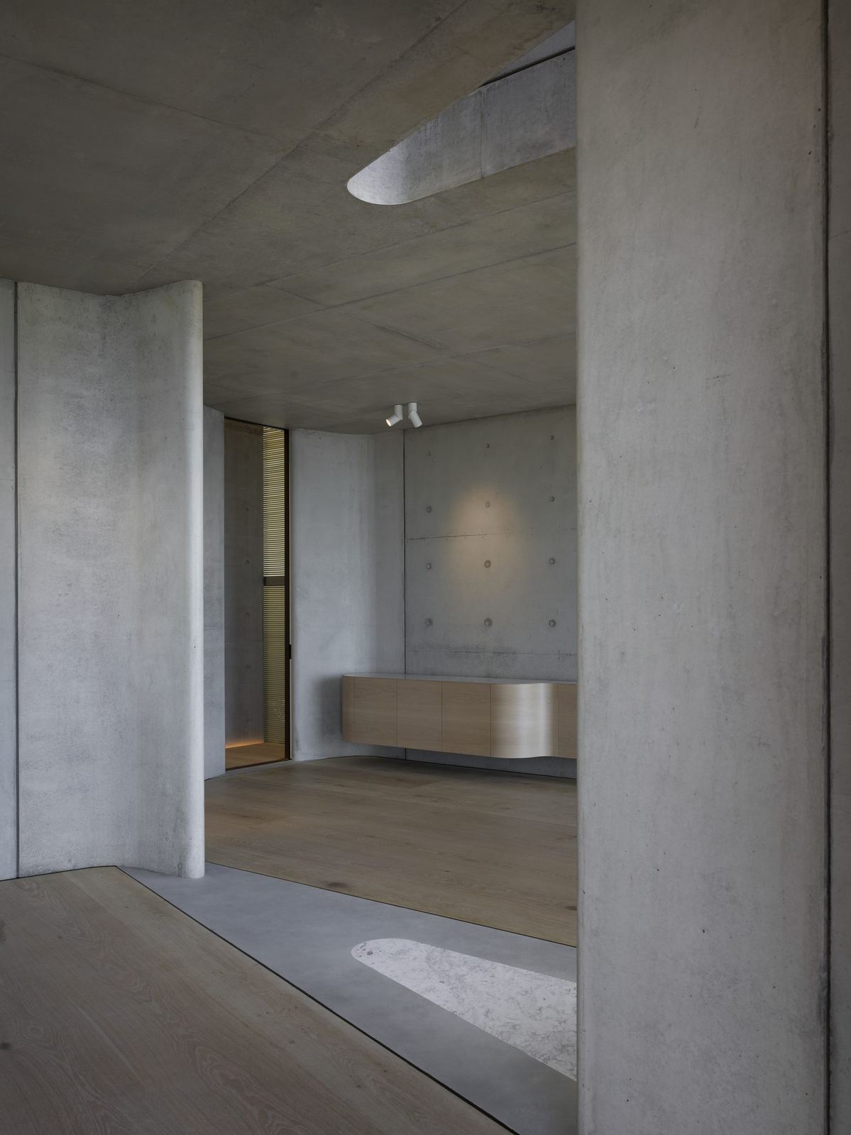 Lurline Bay — off-form concrete interior with timber joinery and a framed opening, built by HP Constructions with FJC Studio