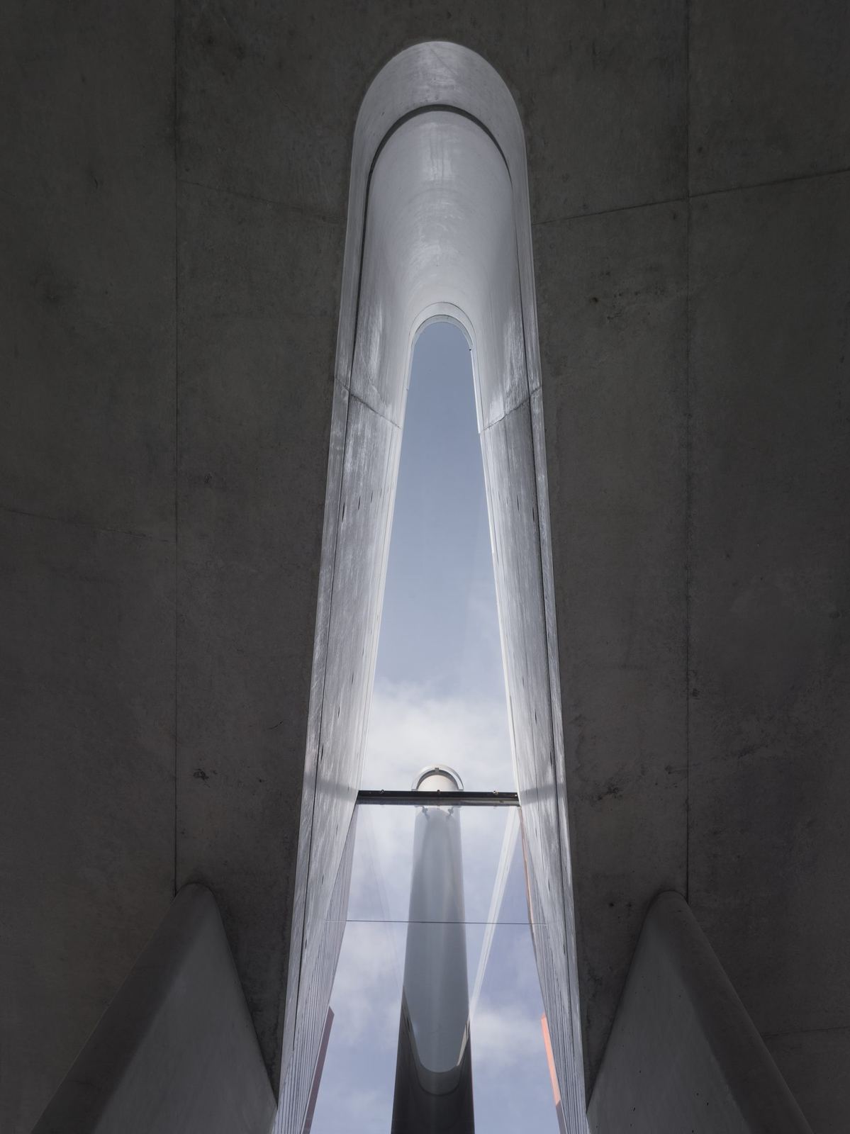 Lurline Bay — board-formed concrete stair void beneath a sculptural skylight, built by HP Constructions with FJC Studio