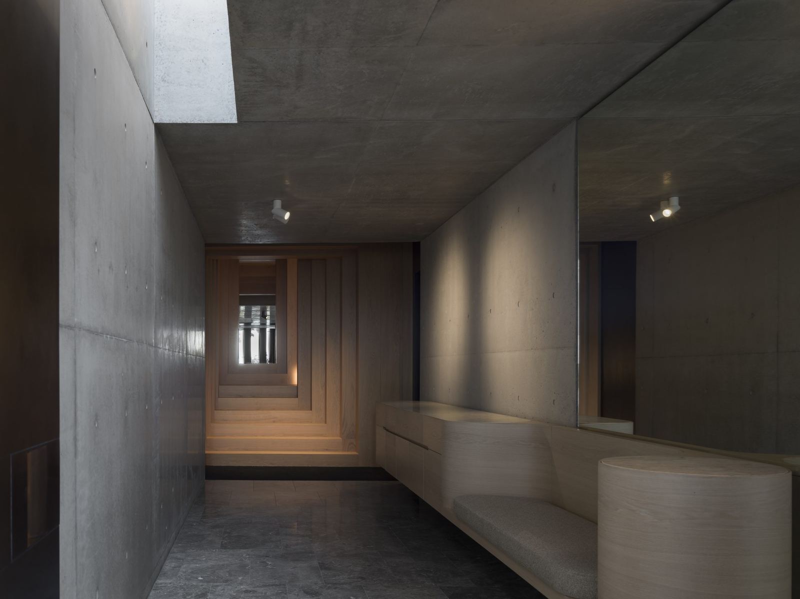 Lurline Bay — concrete gallery hallway with a built-in timber bench, built by HP Constructions with FJC Studio
