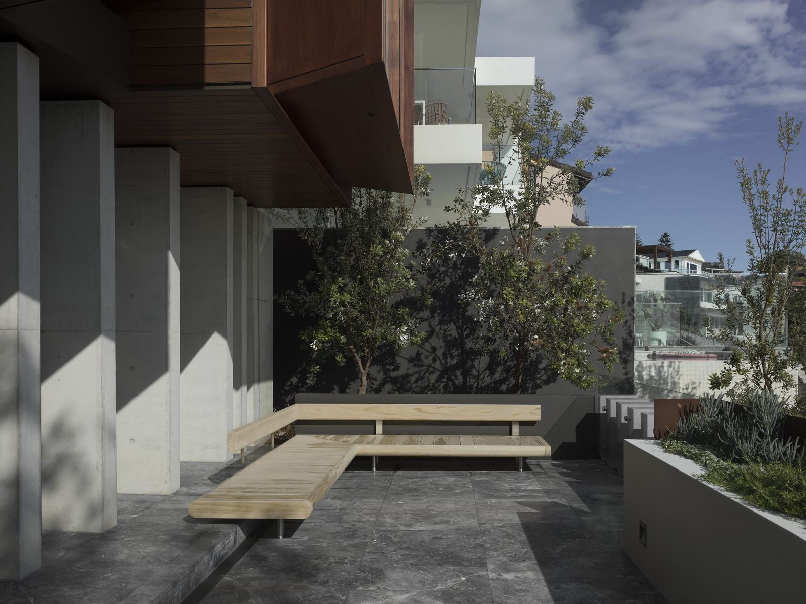 Lurline Bay — landscaped terrace with timber deck and concrete blades, built by HP Constructions with FJC Studio