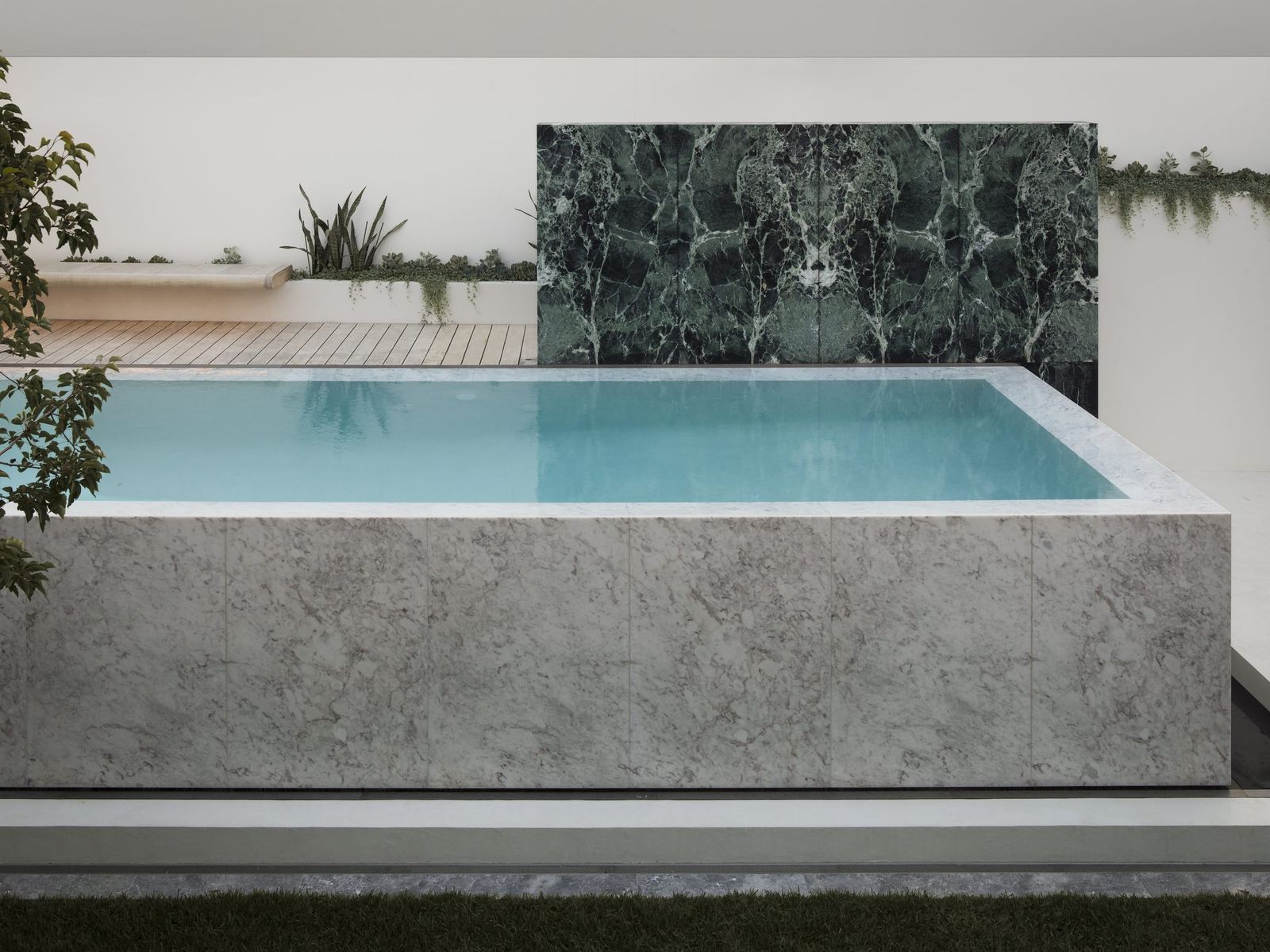 Lurline Bay — marble infinity-edge pool with a green marble feature wall, built by HP Constructions with FJC Studio