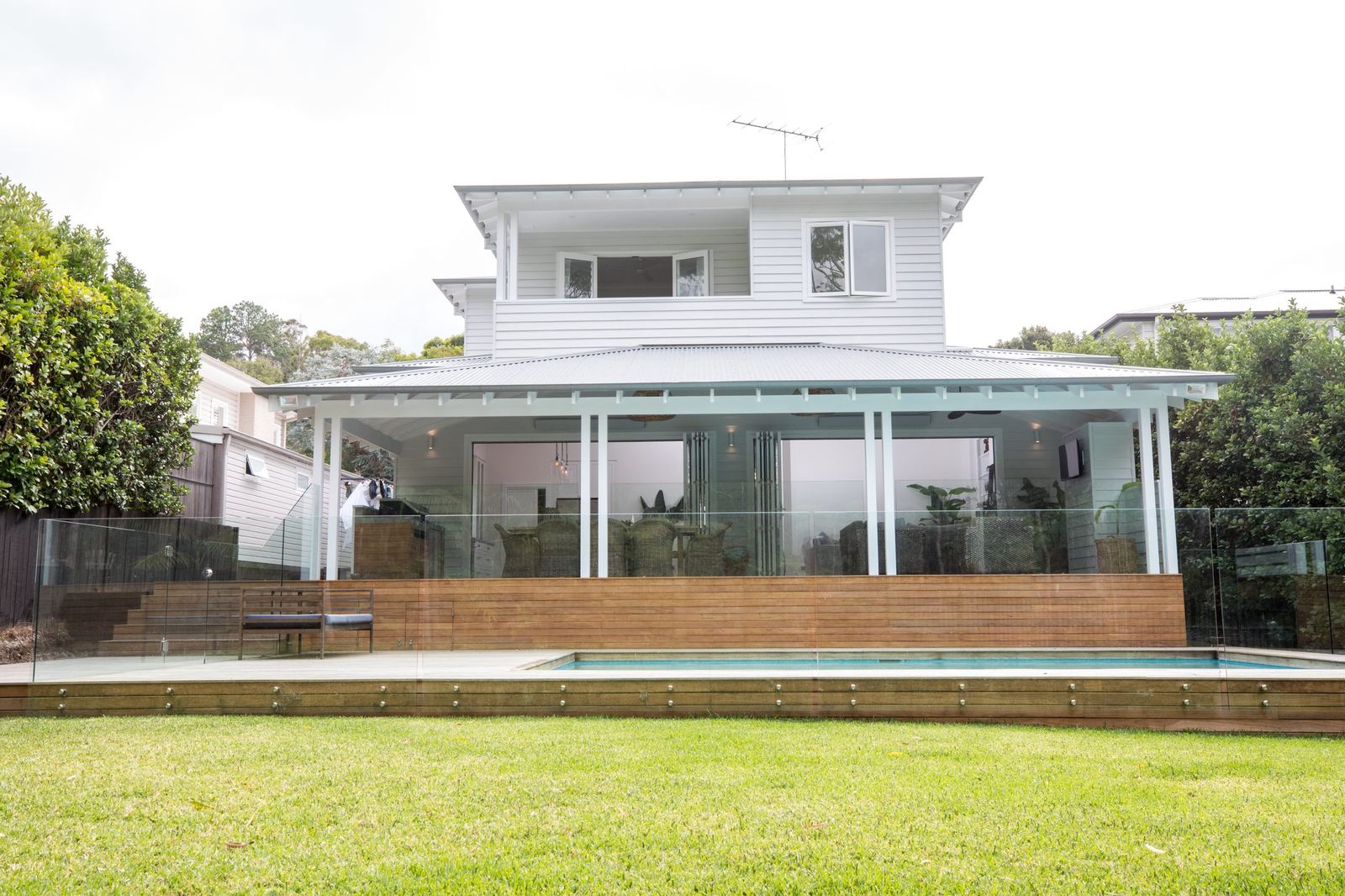 North Balgowlah — rear exterior with covered verandah, glass-fenced pool and deck, built by HP Constructions with J.D Evans & Co