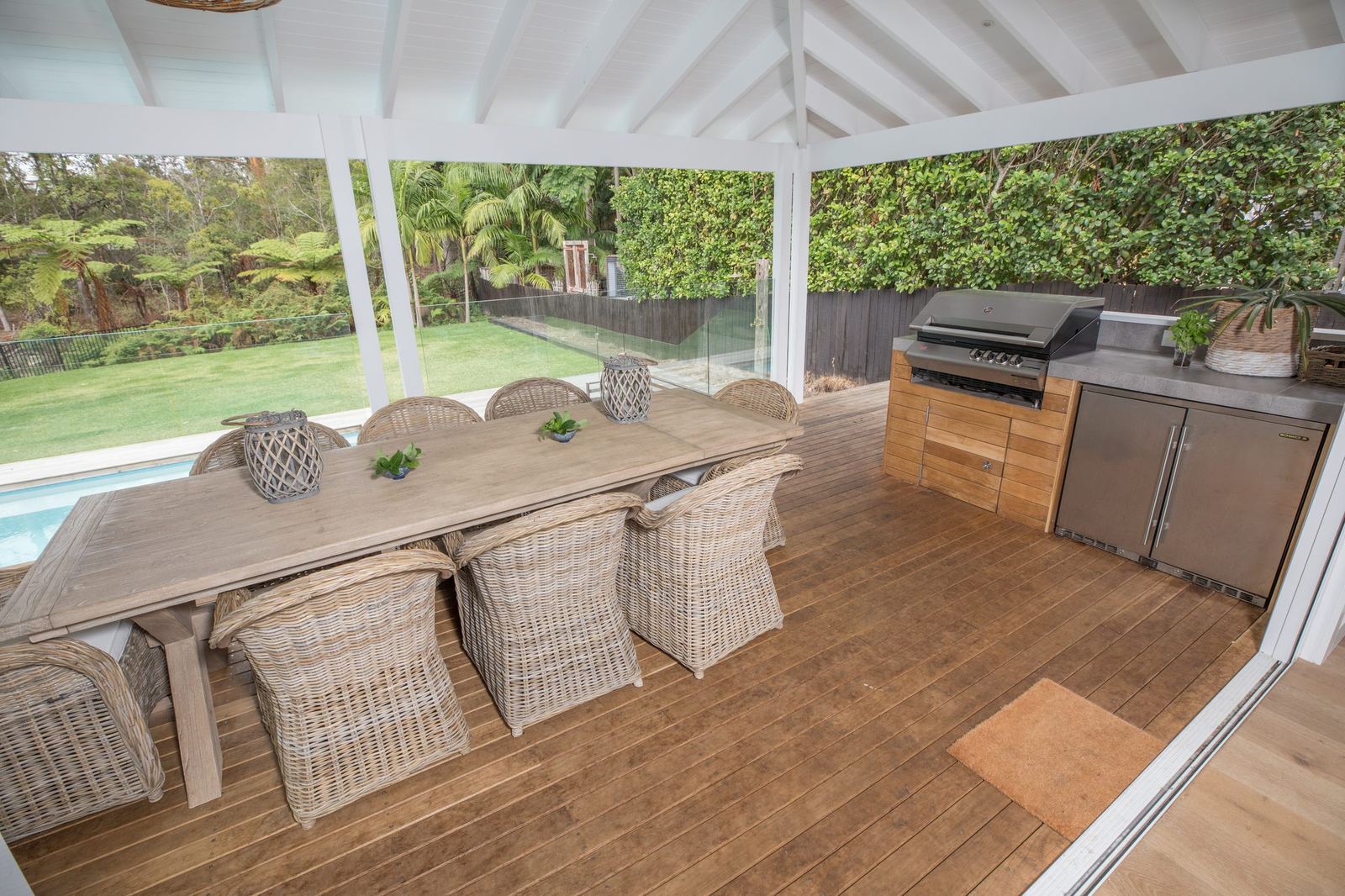 North Balgowlah — covered deck with timber dining table, wicker chairs and barbecue, built by HP Constructions with J.D Evans & Co