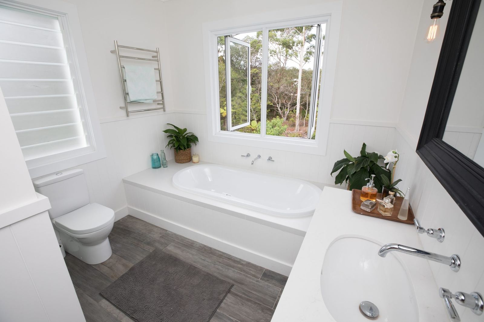 North Balgowlah — bathroom with white bathtub, heated towel rail and window, built by HP Constructions with J.D Evans & Co