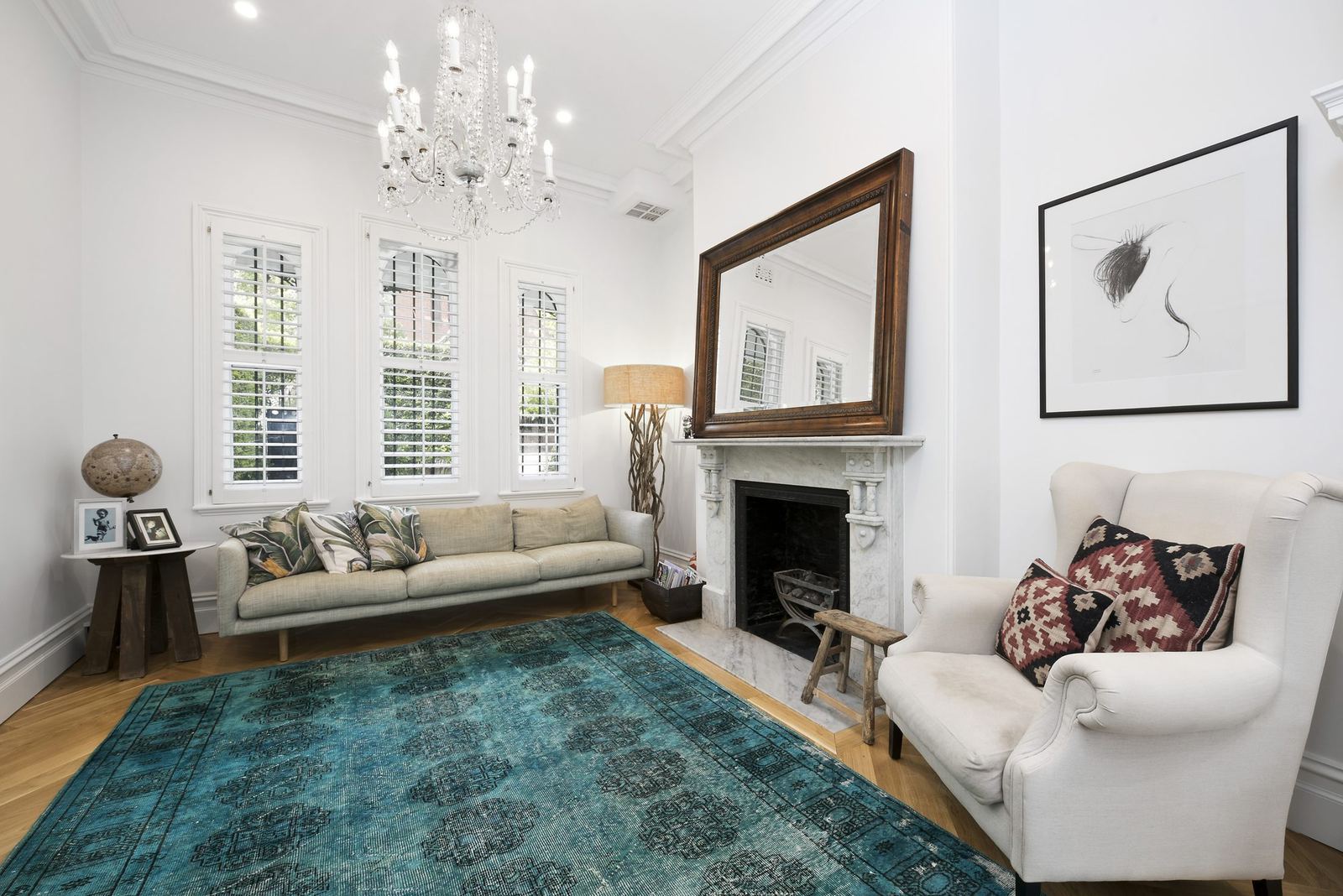 Paddington — formal sitting room with fireplace, chandelier and plantation shutters, built by HP Constructions with Gutnik Design Group