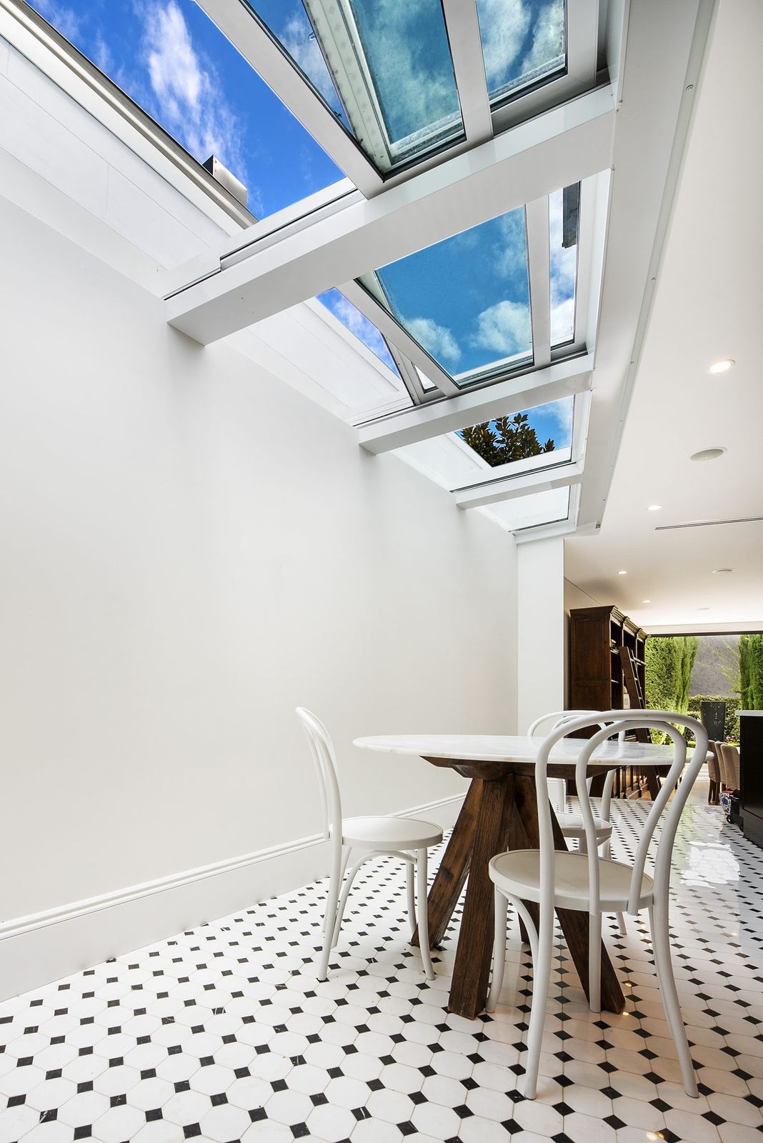 Paddington — dining nook beneath angled glass atrium roof with patterned tiles, built by HP Constructions with Gutnik Design Group
