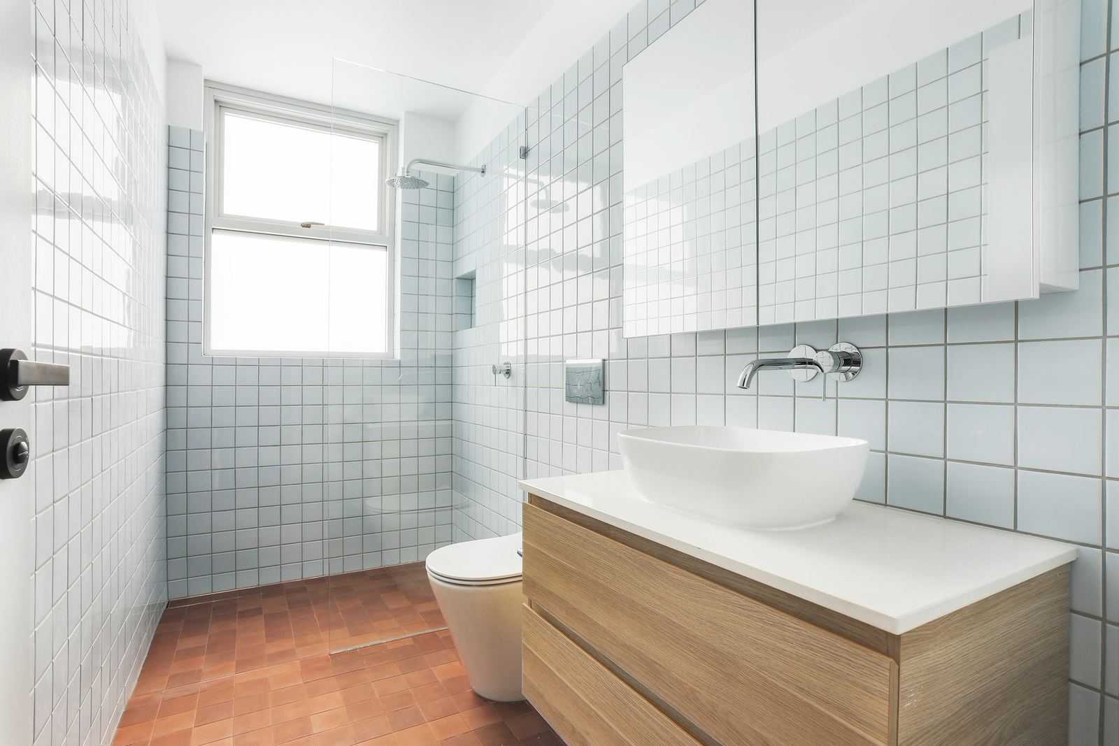 Queens Park Apartments — tiled bathroom with vessel basin, timber vanity and toilet, built by HP Constructions with Ignite Architects