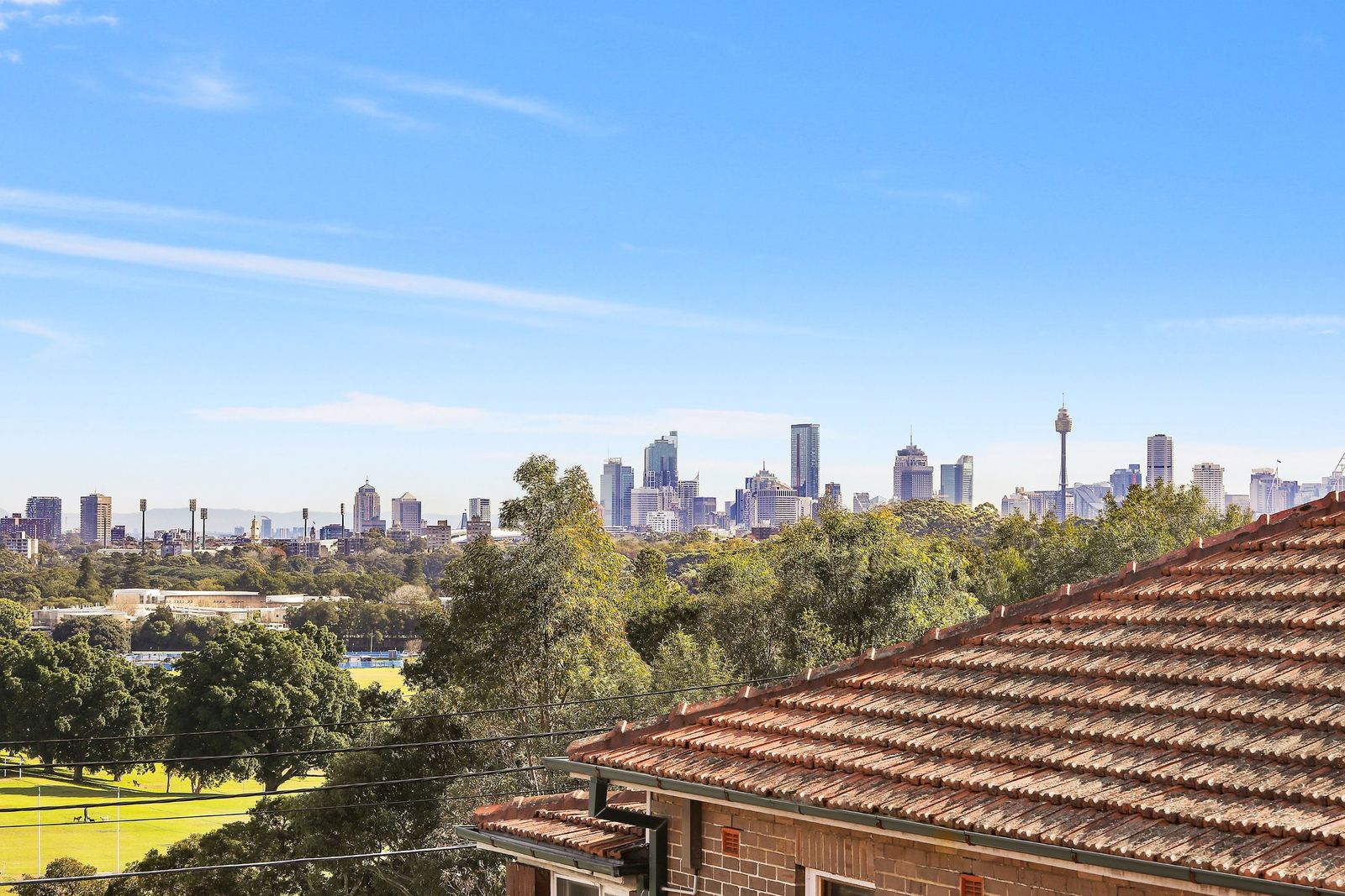 Queens Park Apartments — rooftop outlook toward the Sydney city skyline, built by HP Constructions with Ignite Architects