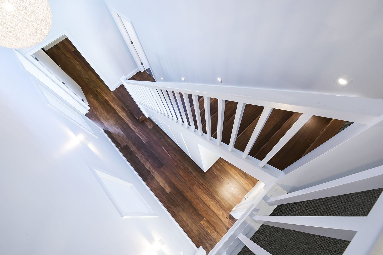 Seaforth — overhead view of a timber staircase with white balustrade and carpet, built by HP Constructions with Playoust Churcher