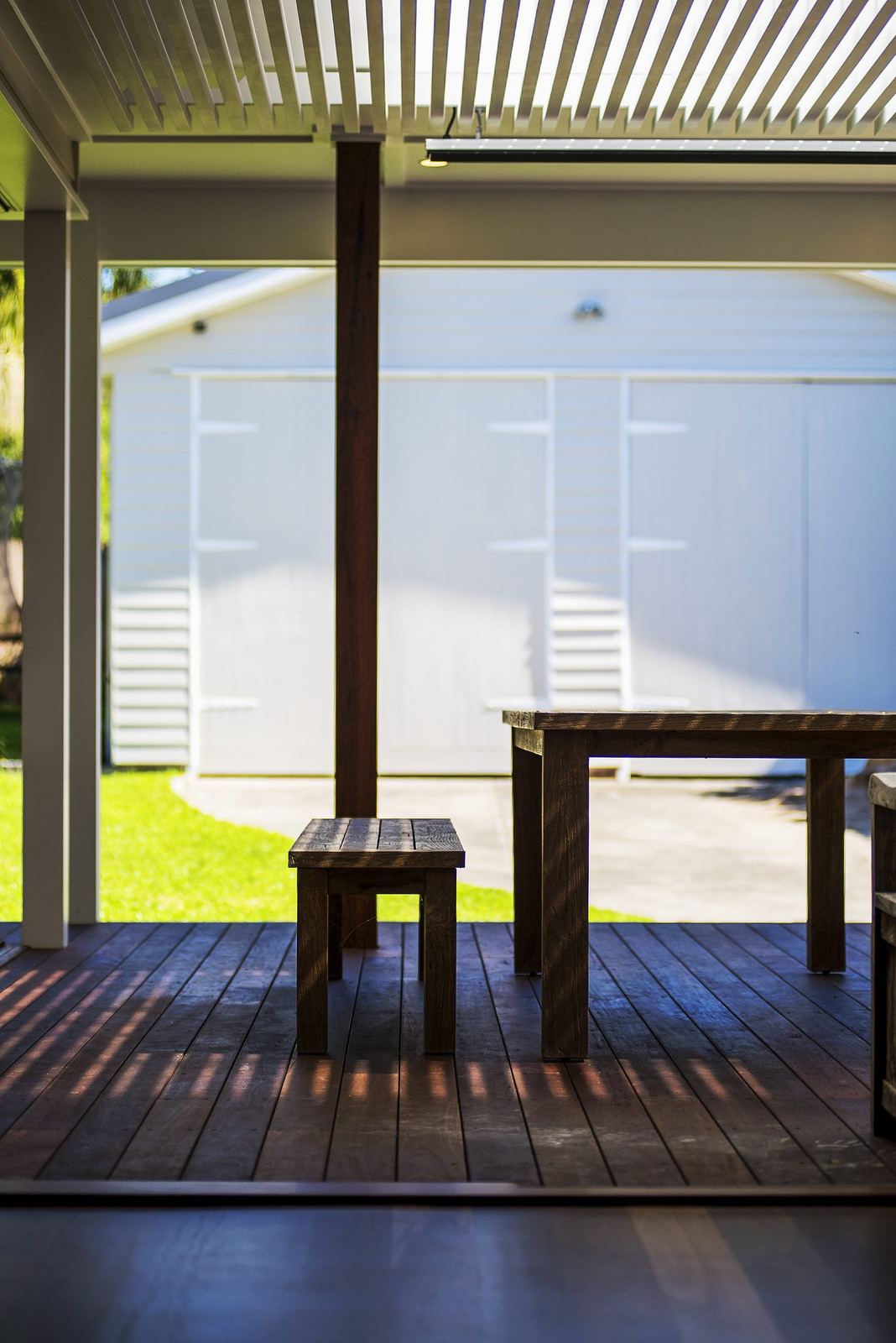 Seaforth — covered timber deck with battened screen, spotted gum boards and lawn, built by HP Constructions with Playoust Churcher