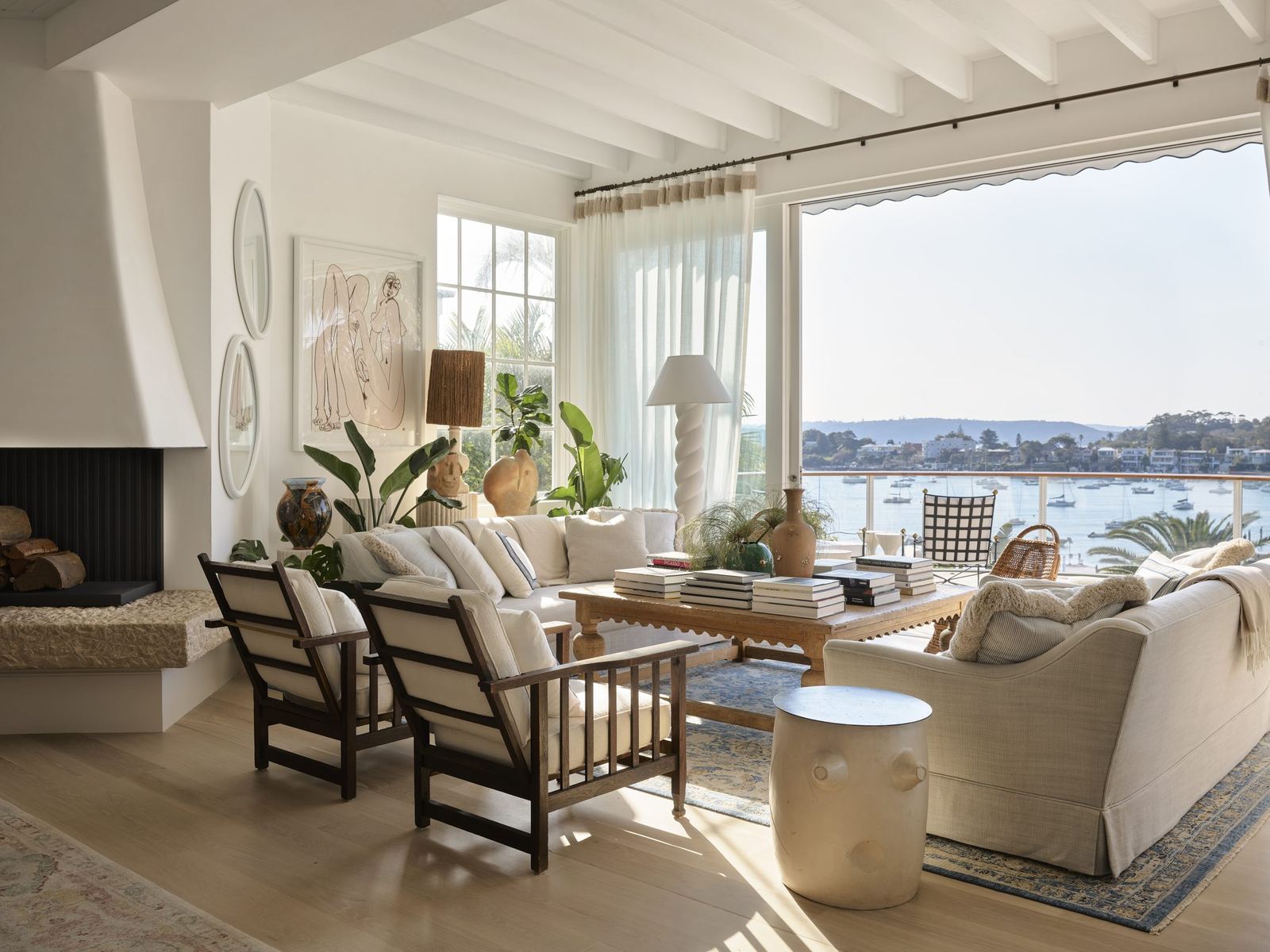 Vaucluse — living room with fireplace and sliding doors opening to harbour views, built by HP Constructions with Alexander & Co