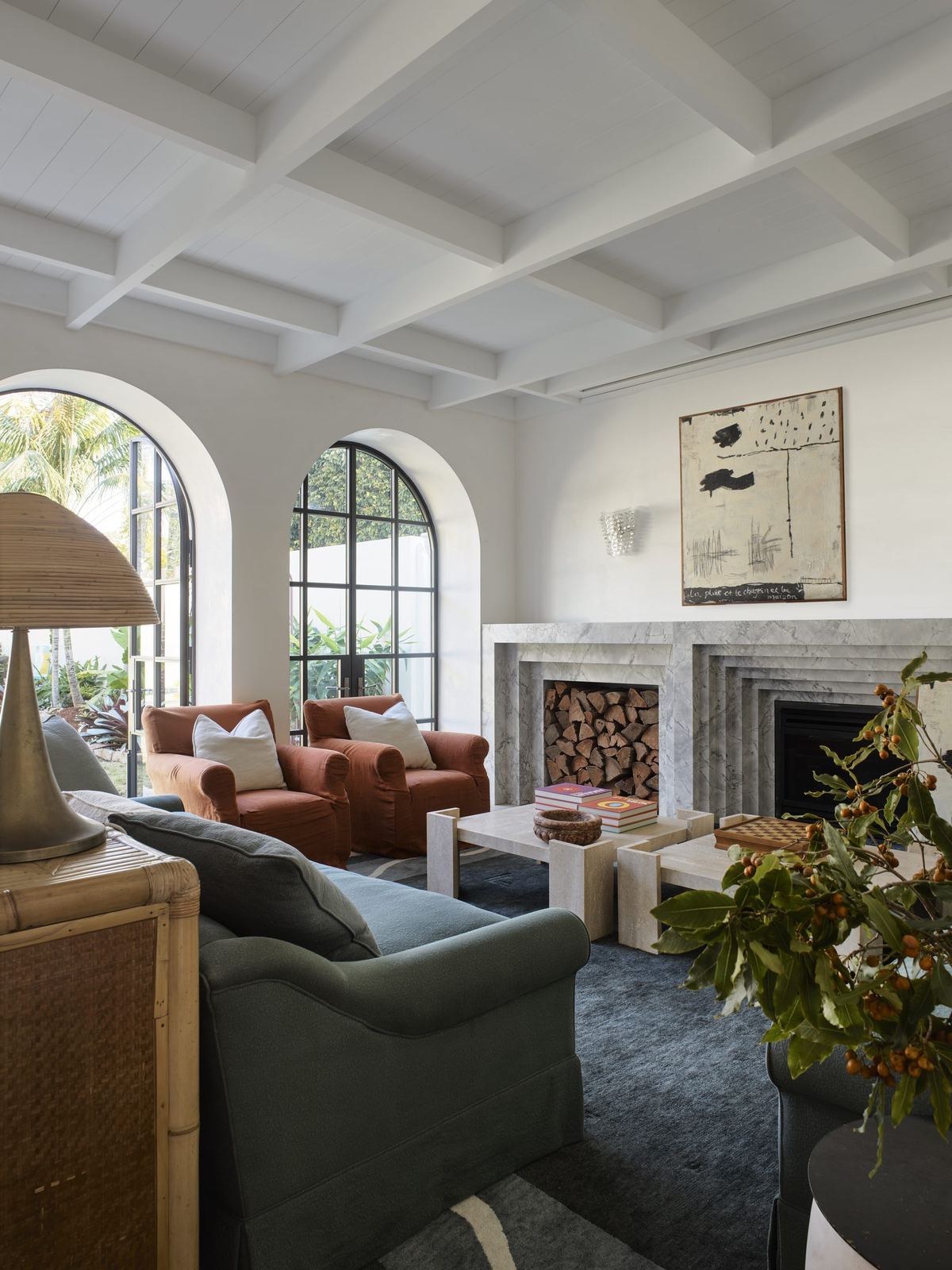 Vaucluse — living room with arched window, fireplace and upholstered armchairs, built by HP Constructions with Alexander & Co