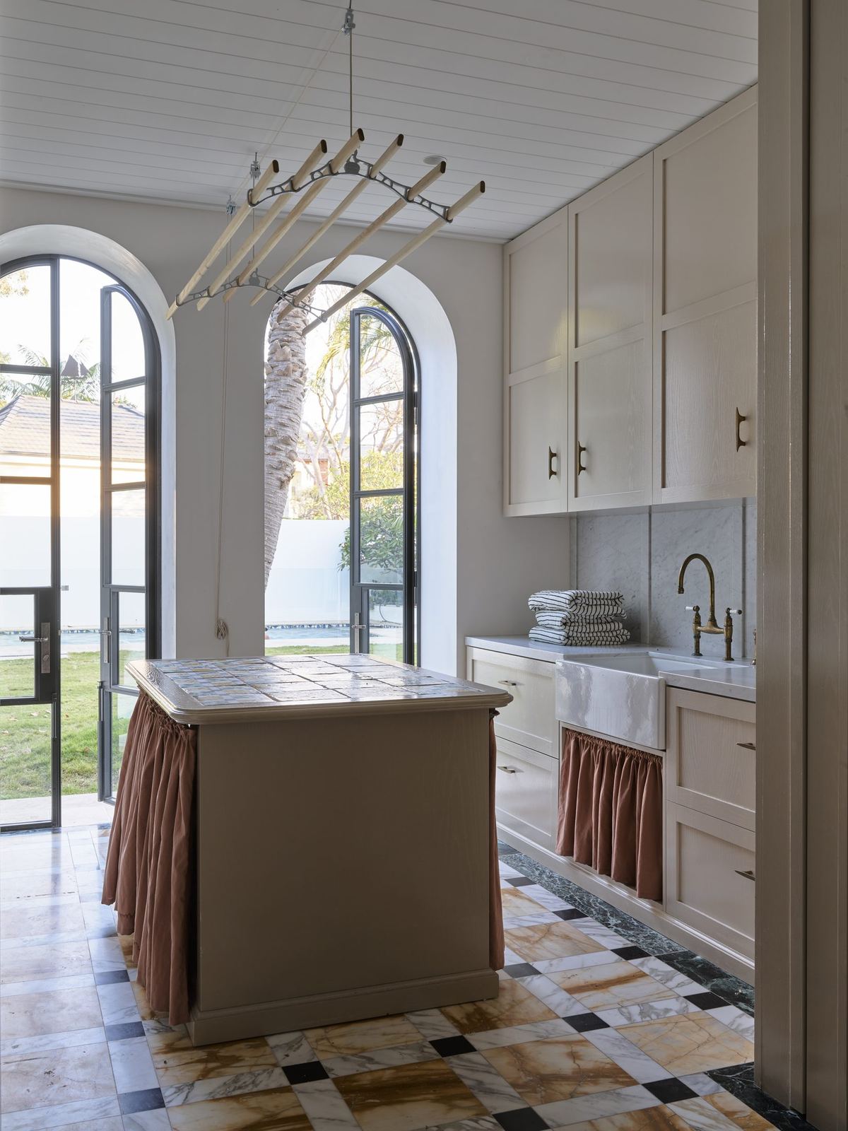 Vaucluse — scullery with skirted island, arched window and water view beyond, built by HP Constructions with Alexander & Co