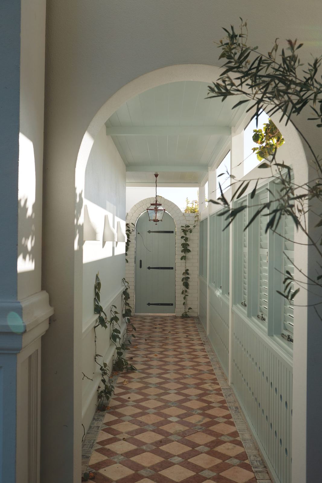 Vaucluse — arched hallway with patterned tiled floor and trained climbing plants, built by HP Constructions with Alexander & Co