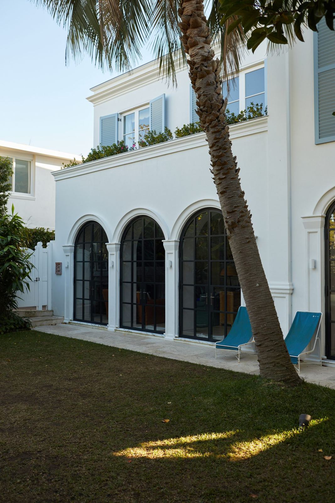 Vaucluse — rear exterior with arched windows, lawn and palm tree, built by HP Constructions with Alexander & Co