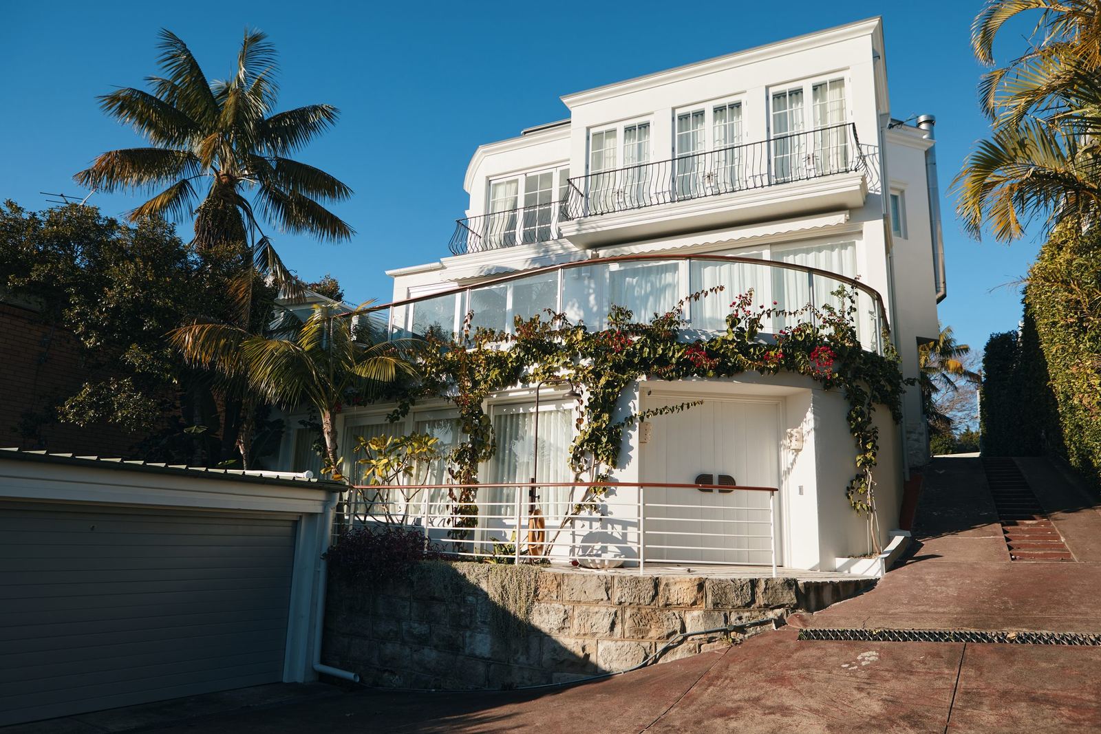 Vaucluse — white multi-storey residence exterior with balconies and palm trees, built by HP Constructions with Alexander & Co
