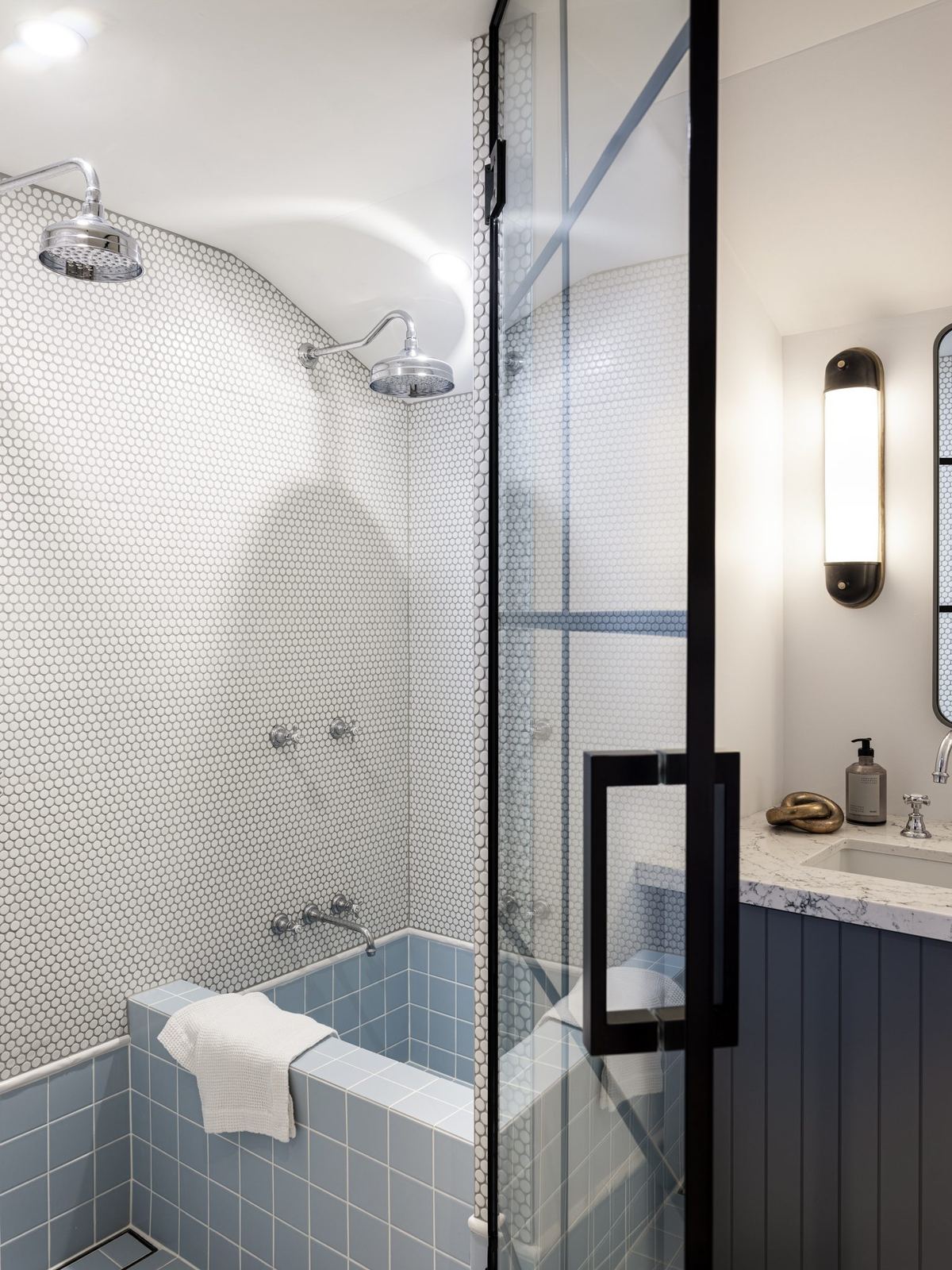 Willoughby — bathroom with blue-tiled bath and framed glass shower, built by HP Constructions with Alexander & Co
