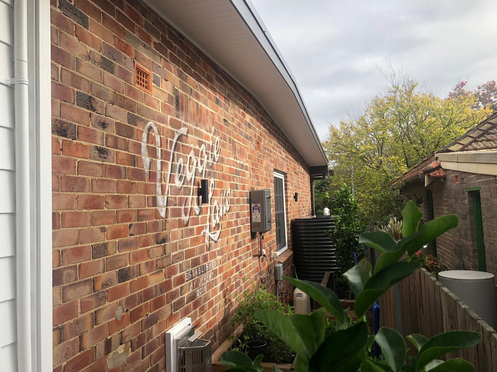 Willoughby — heritage brick exterior wall with signage and garden, built by HP Constructions with Alexander & Co